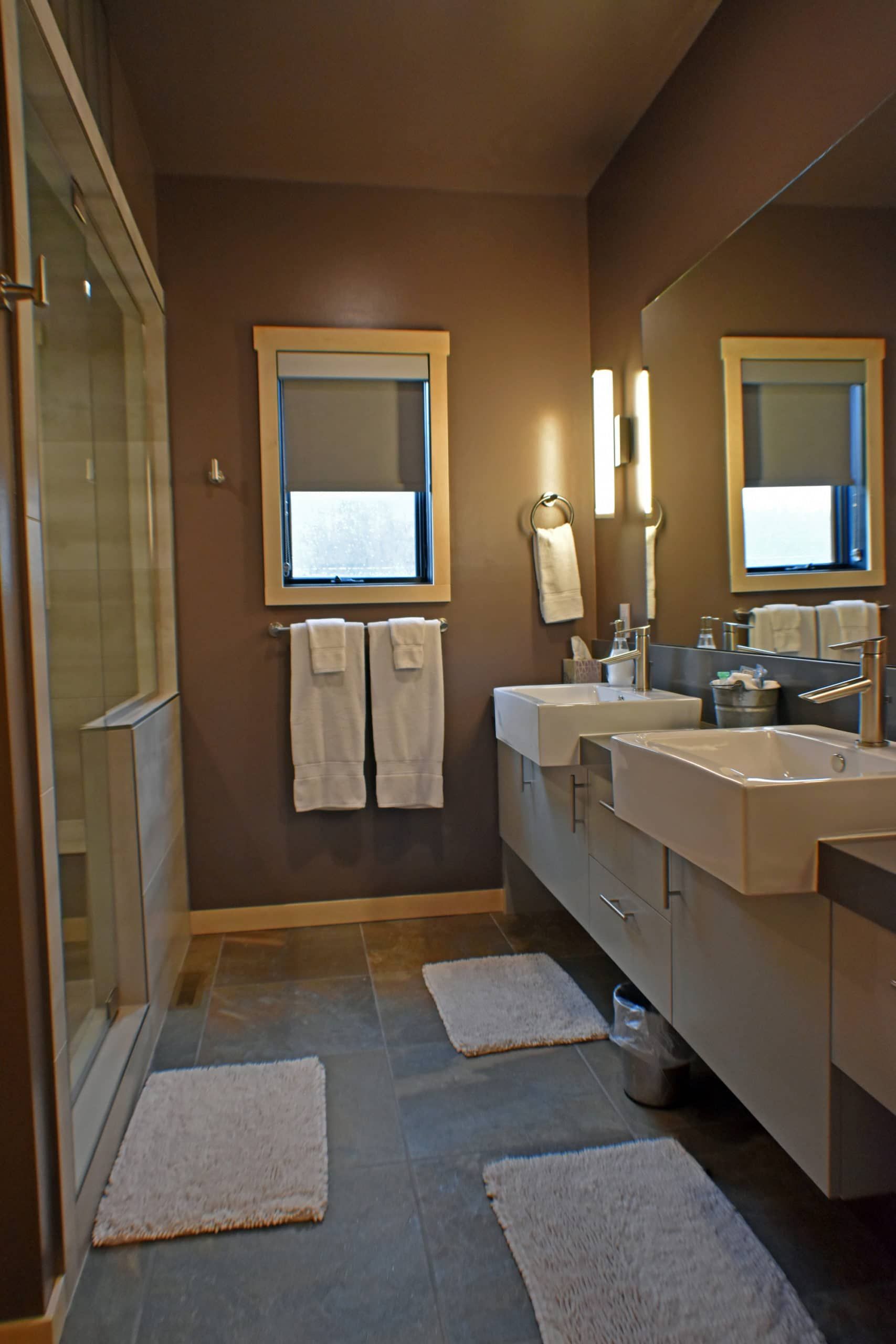A bathroom with two sinks and two mirrors