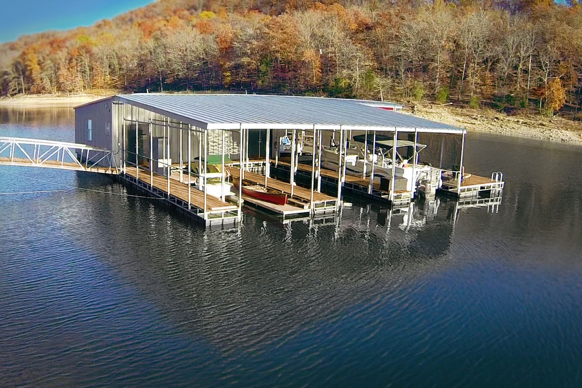 A dock with boats docked in it on a lake.
