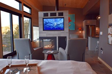 A living room with a fireplace and a flat screen tv