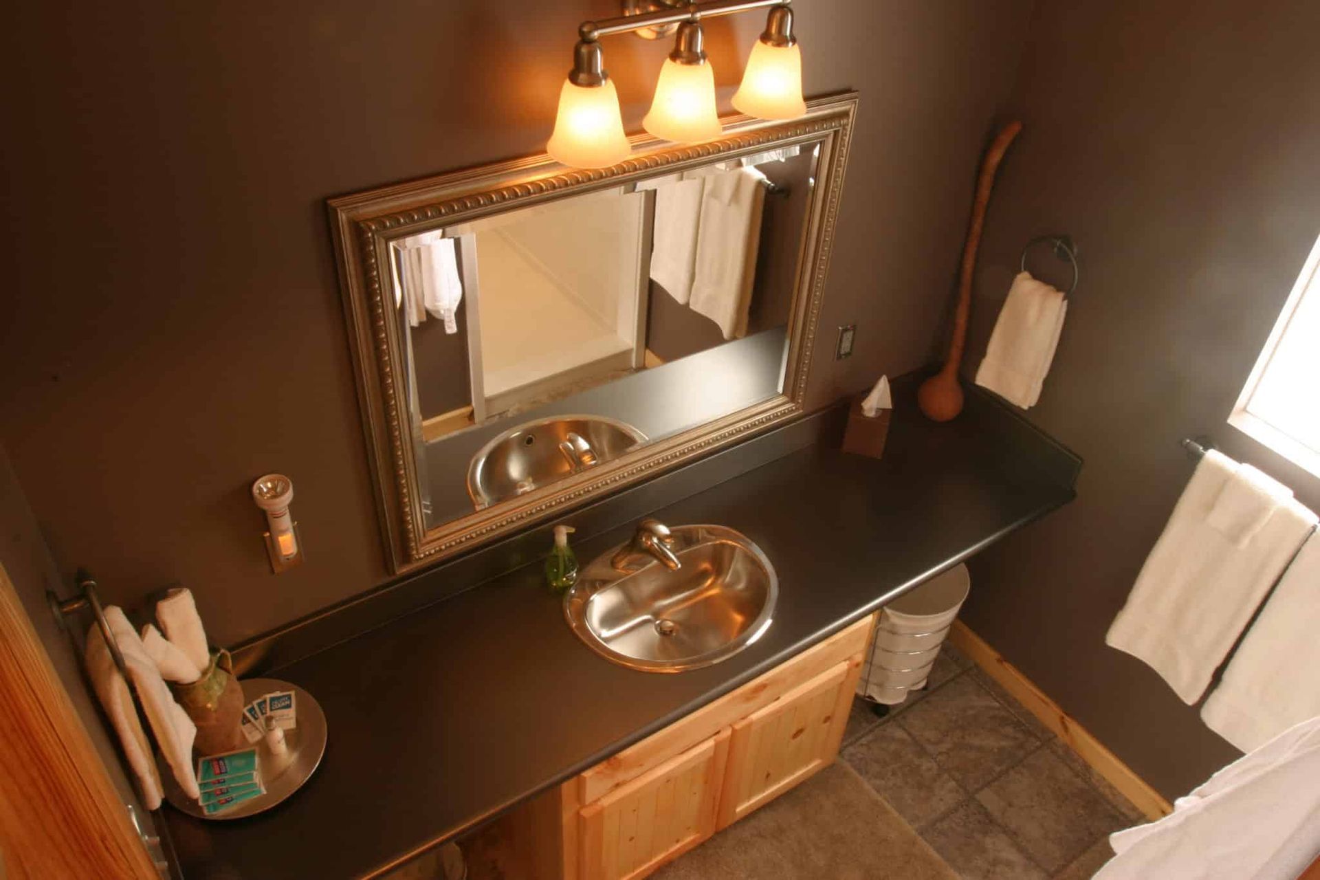 A bathroom with two sinks and a large mirror.