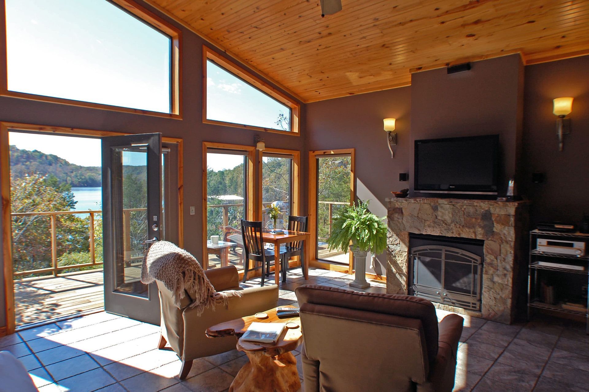 A living room with a fireplace and lots of windows