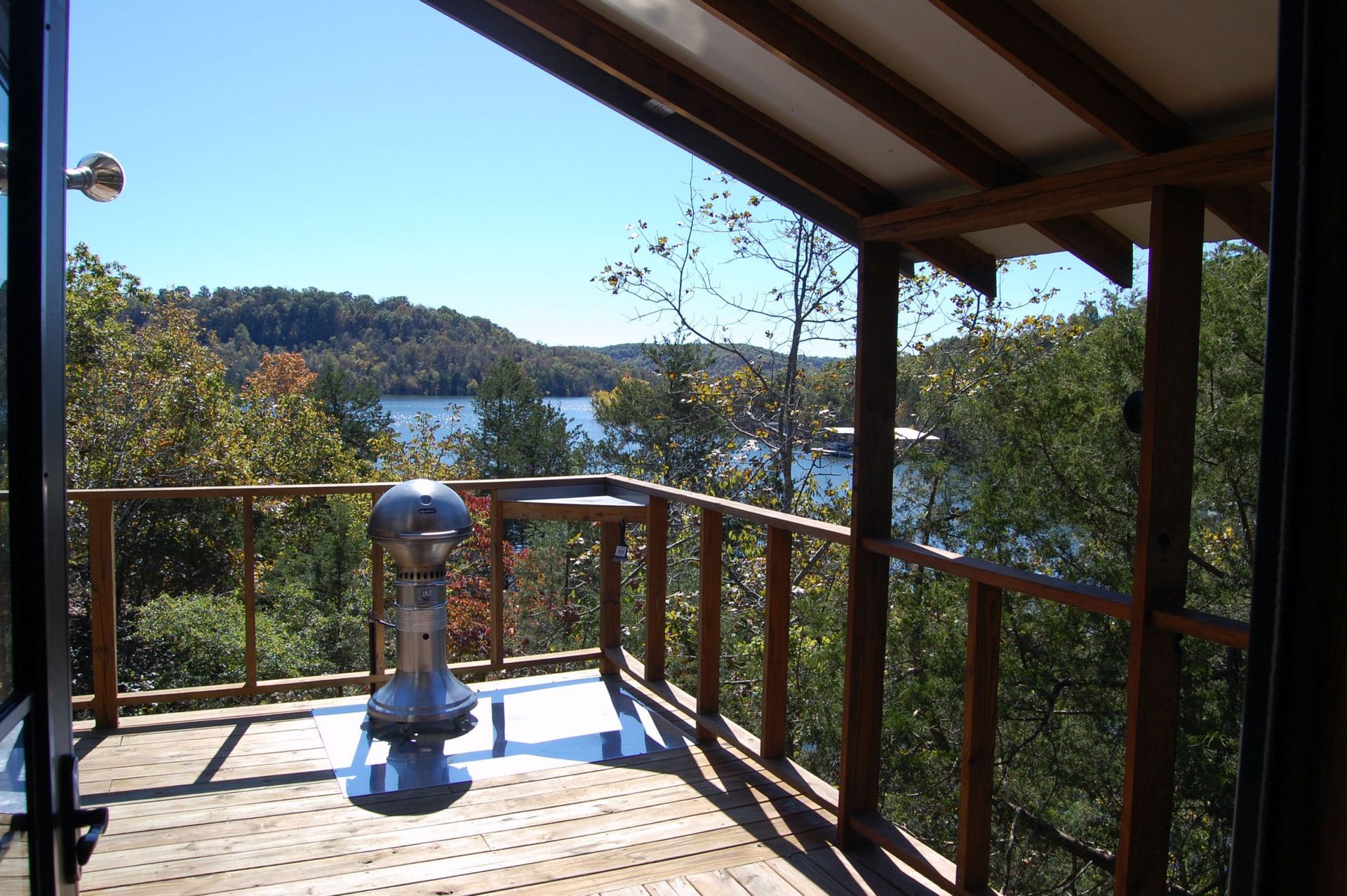 A deck with a view of a lake and trees