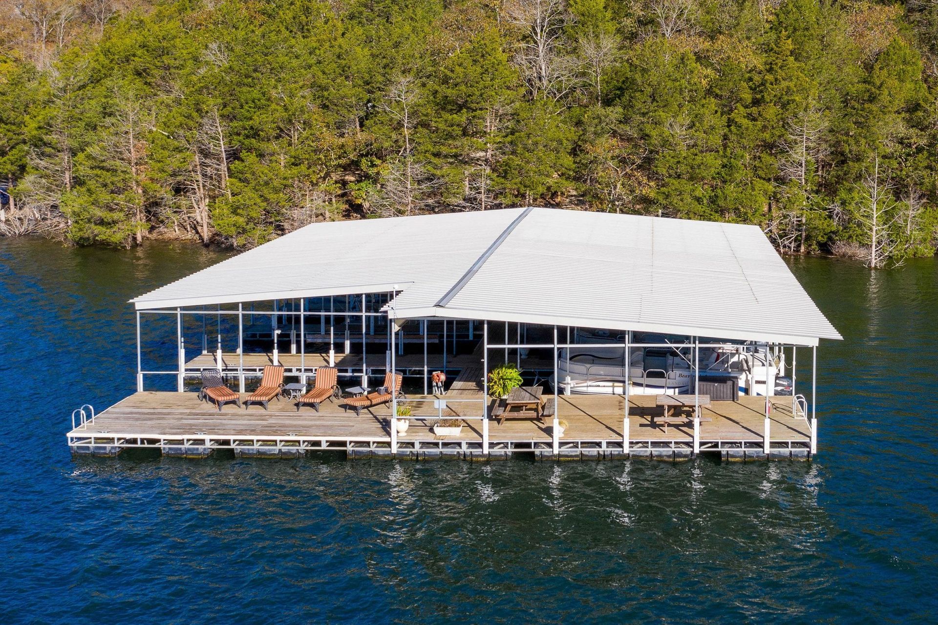 An aerial view of a floating house on a lake.