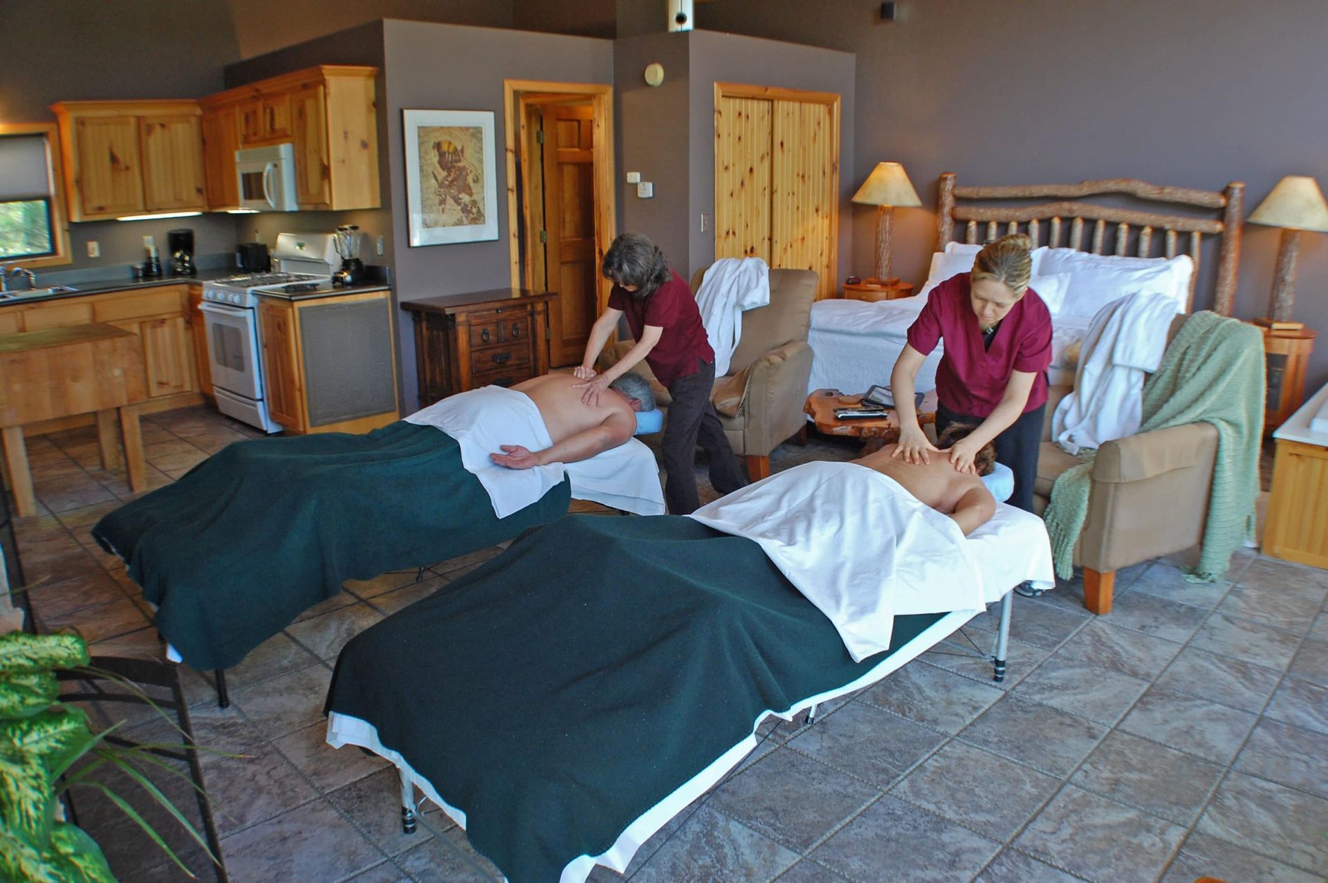 Two people are getting massages in a hotel room
