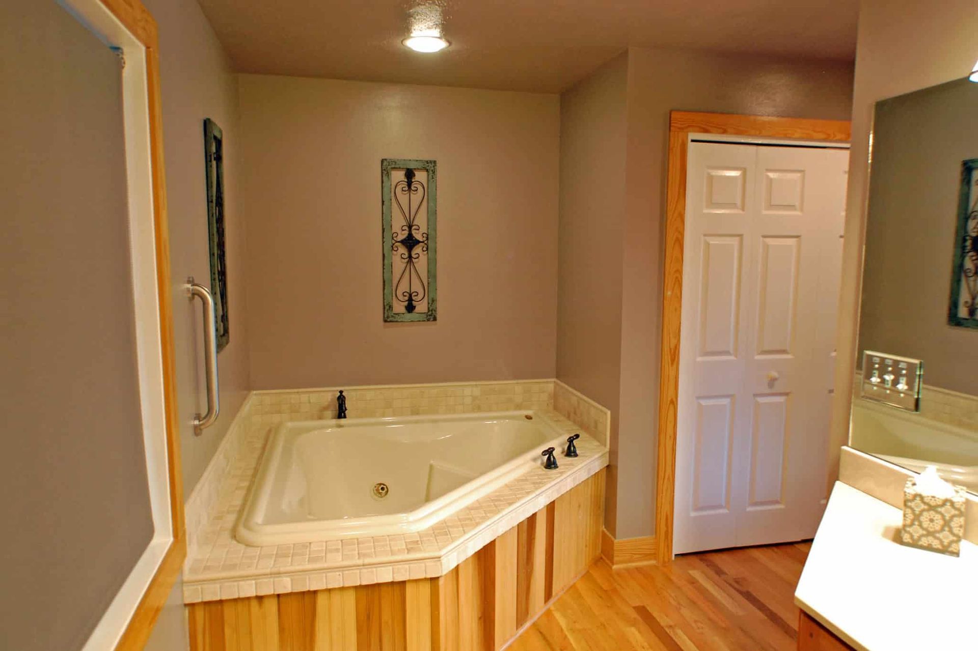 A bathroom with a jacuzzi tub and a sink.