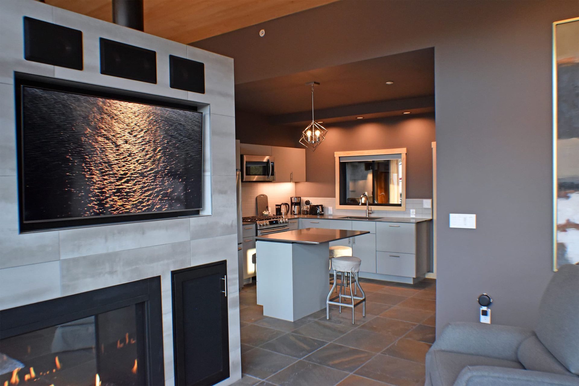 A living room with a fireplace and a kitchen