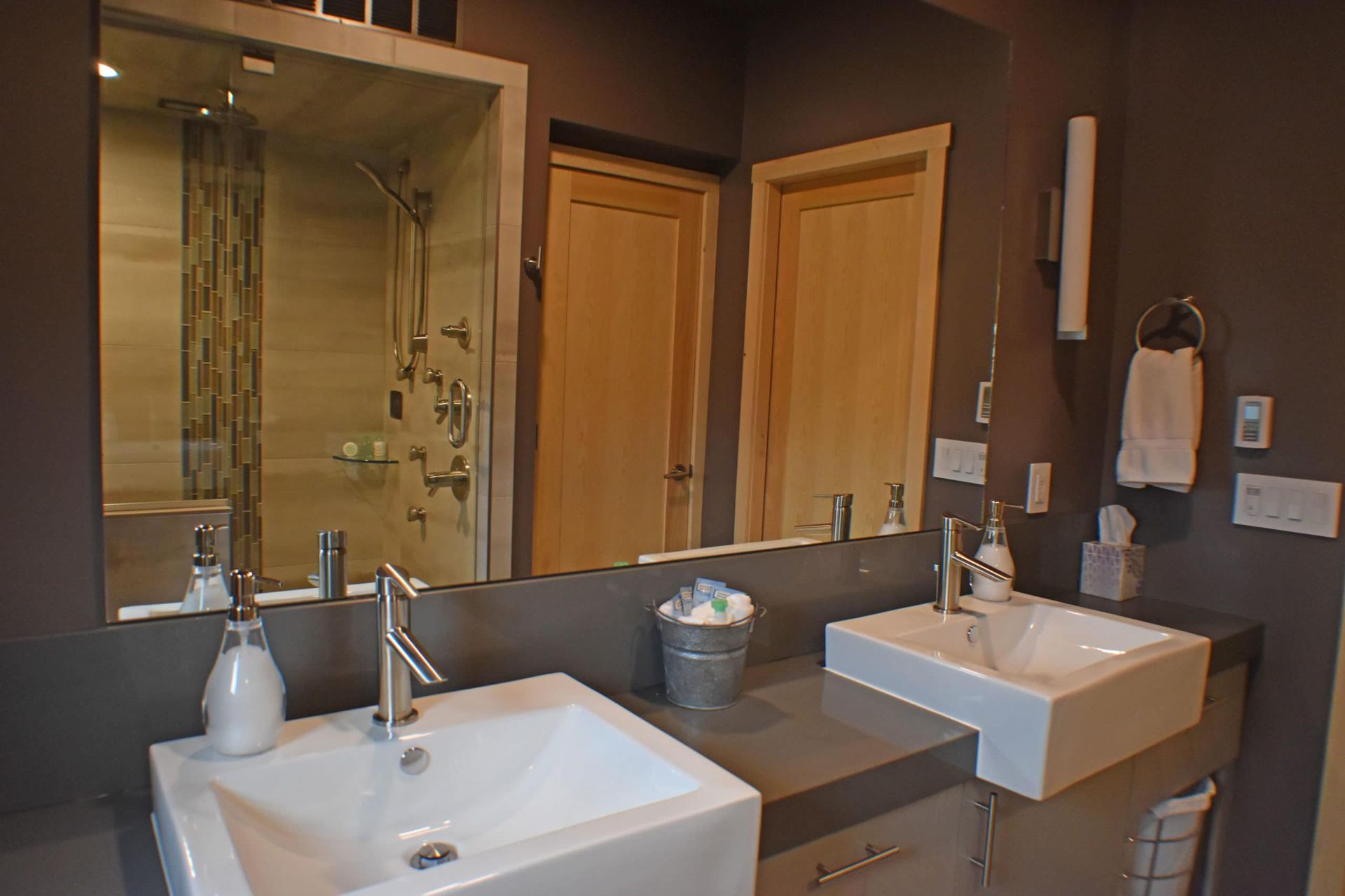 A bathroom with two sinks and a large mirror