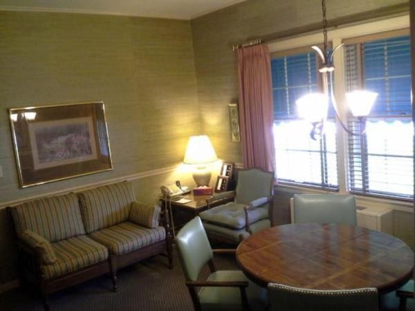 A living room with a couch a table and chairs