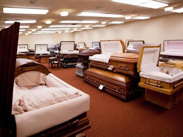 A room filled with lots of coffins including one that is open