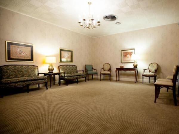 A waiting room with a couch and chairs in it
