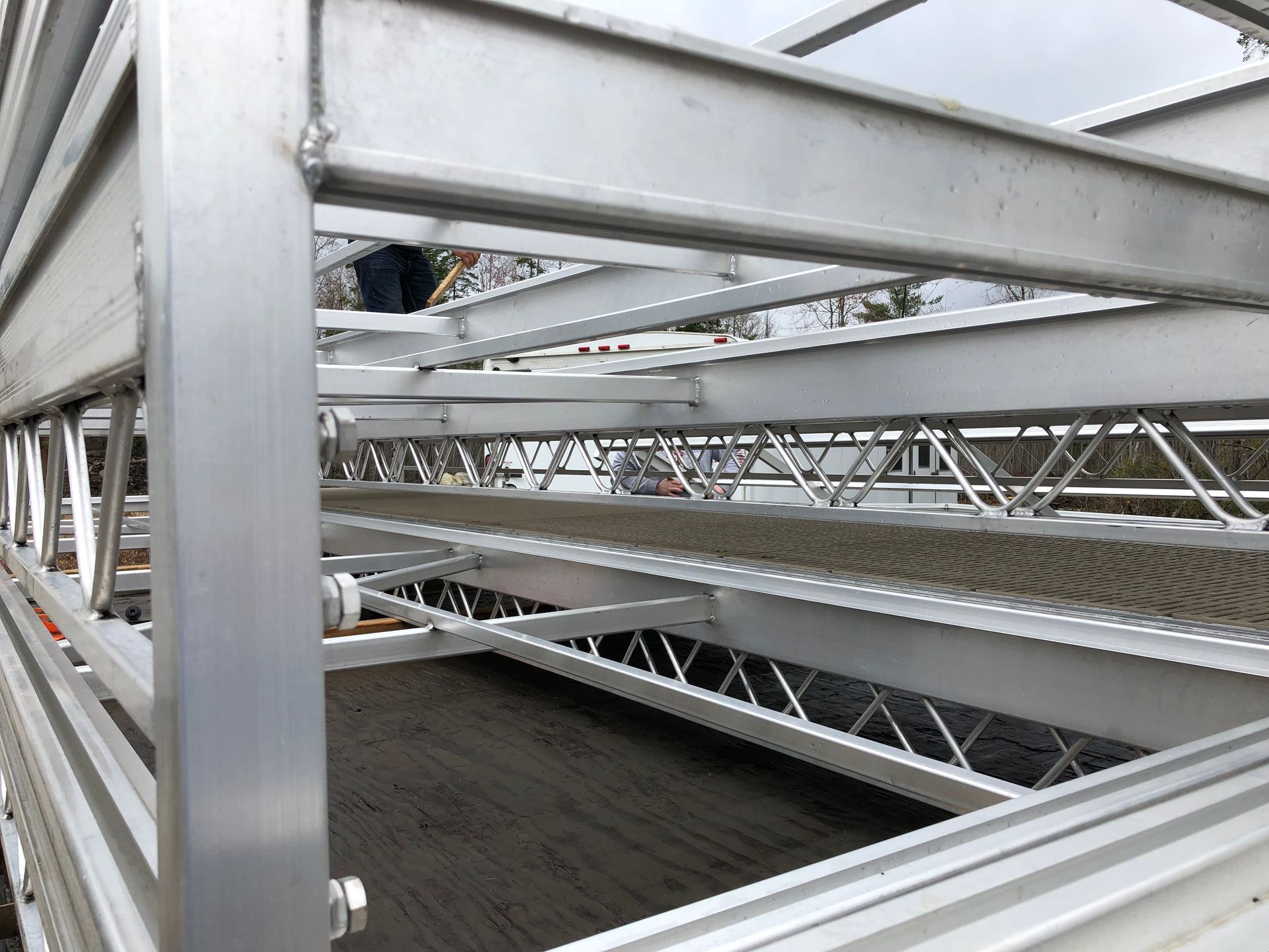 A close up of a metal structure with a person standing in the background.