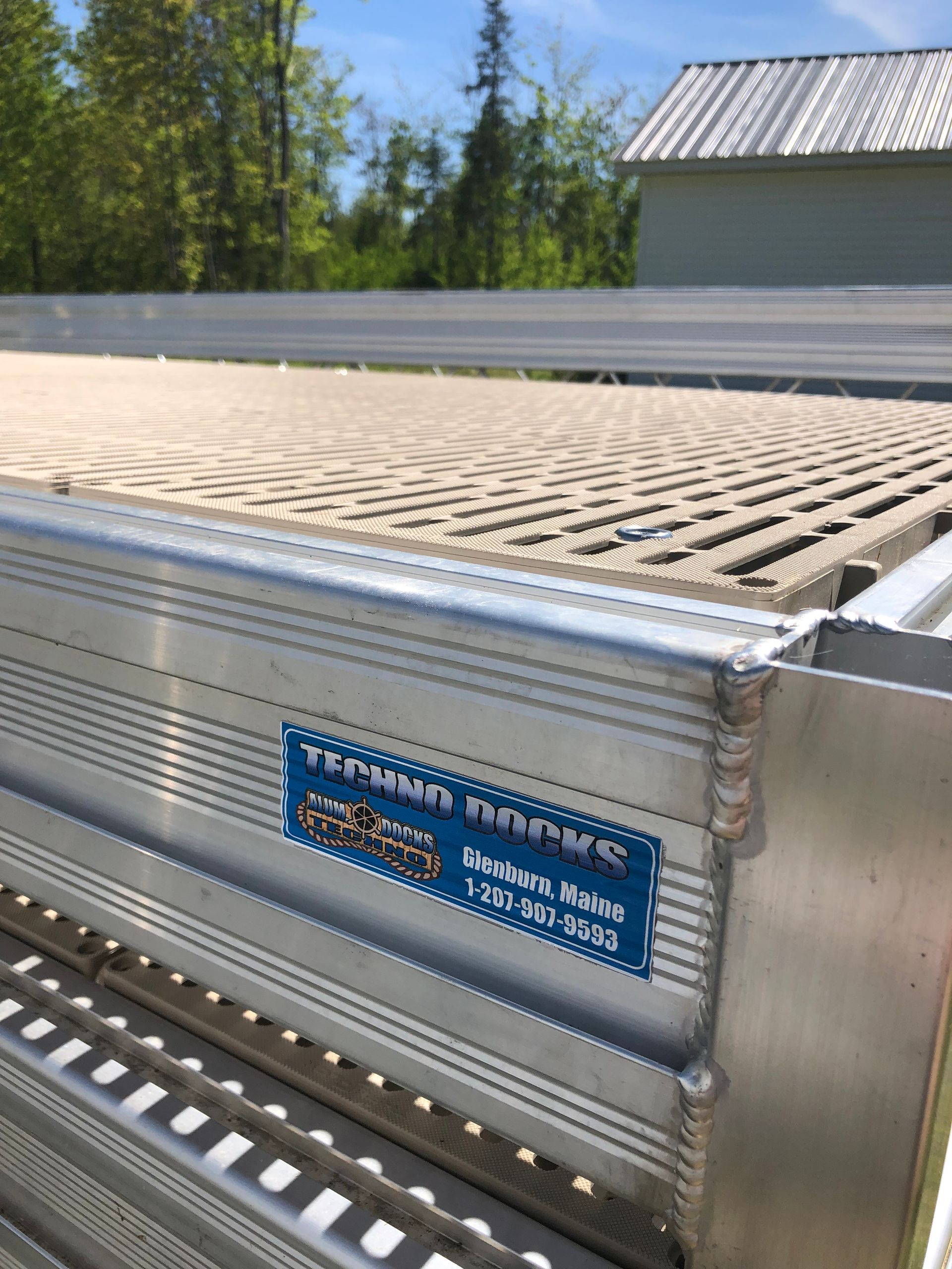 A close up of a metal railing with a sticker on it.