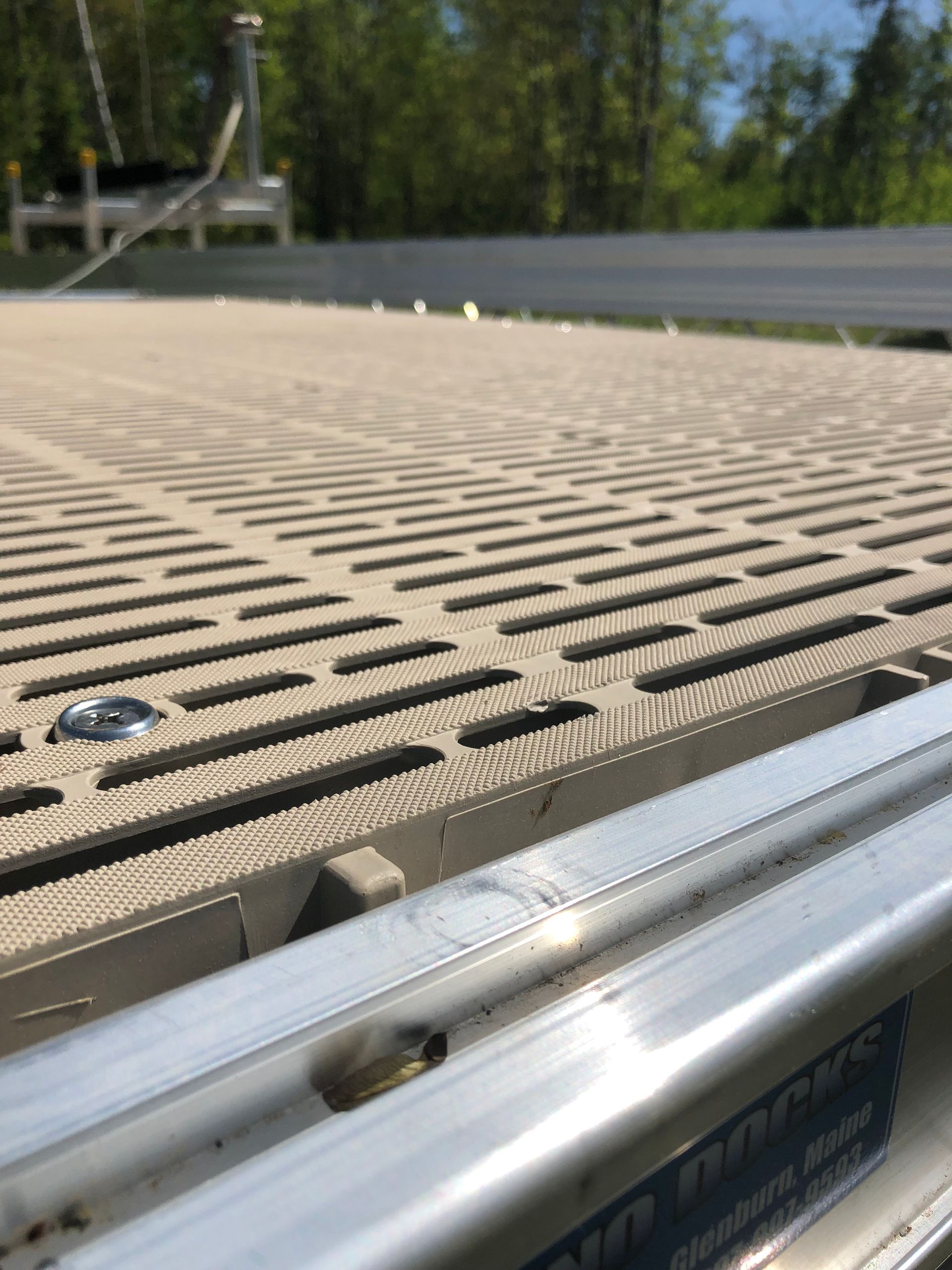 A close up of a dock with a metal railing