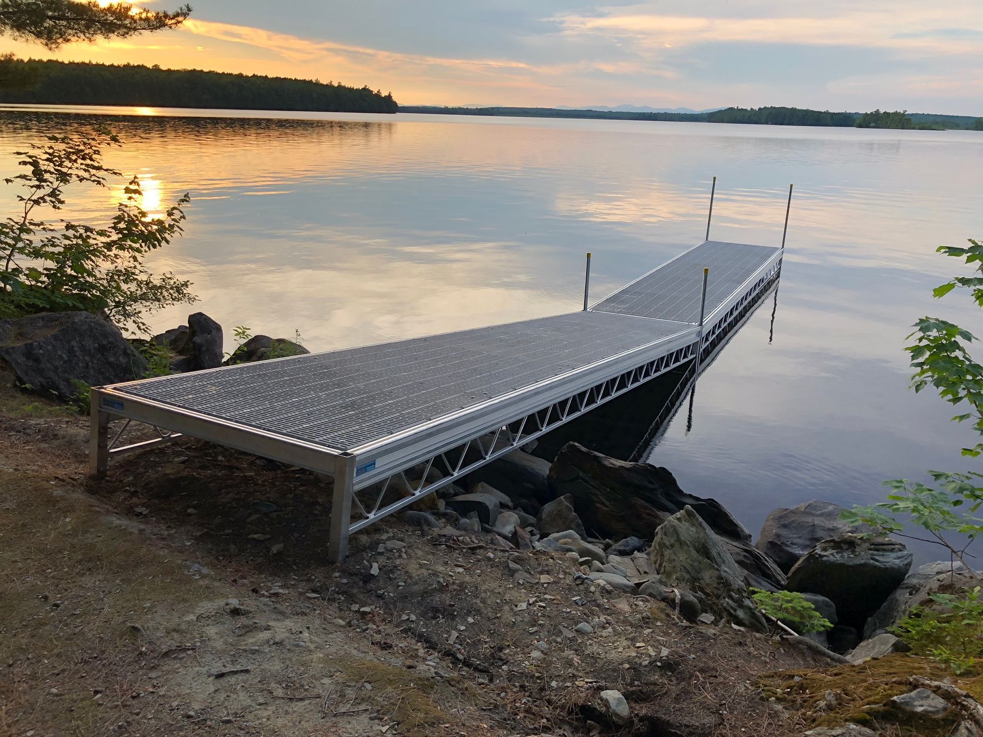 A dock is sitting on the shore of a lake.