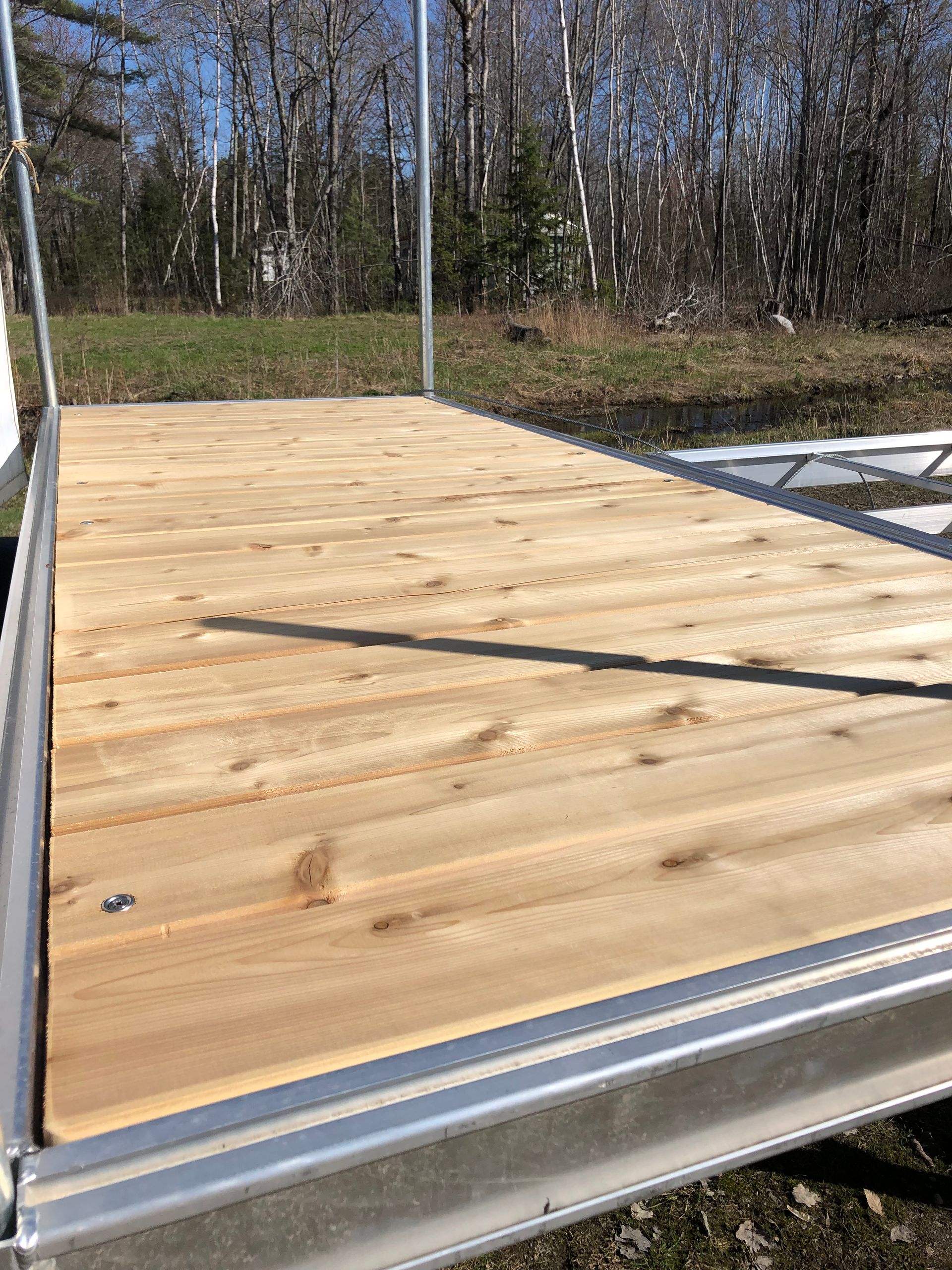 A wooden deck is sitting on top of a metal frame.