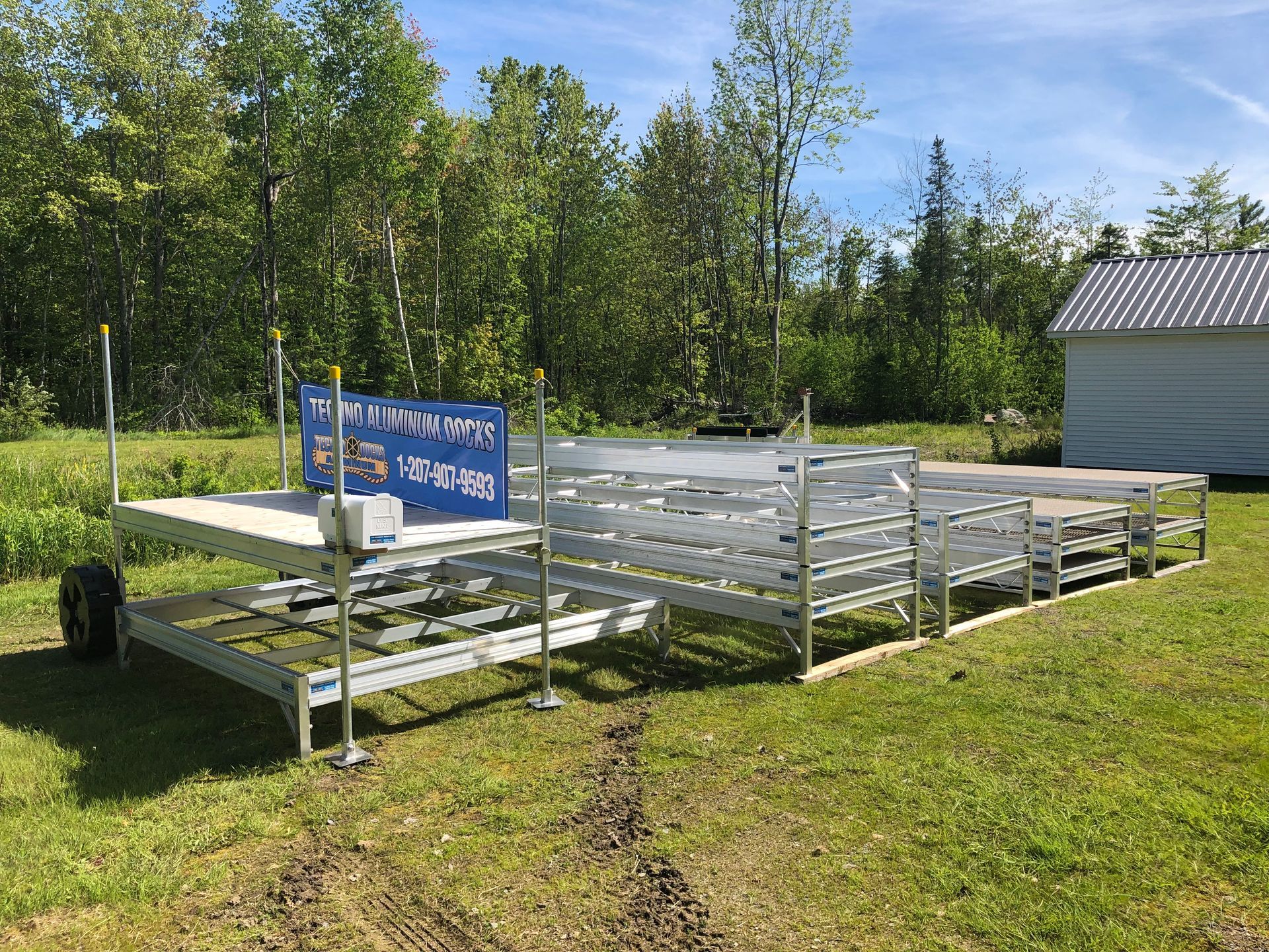 A row of bleachers are sitting on top of a lush green field.
