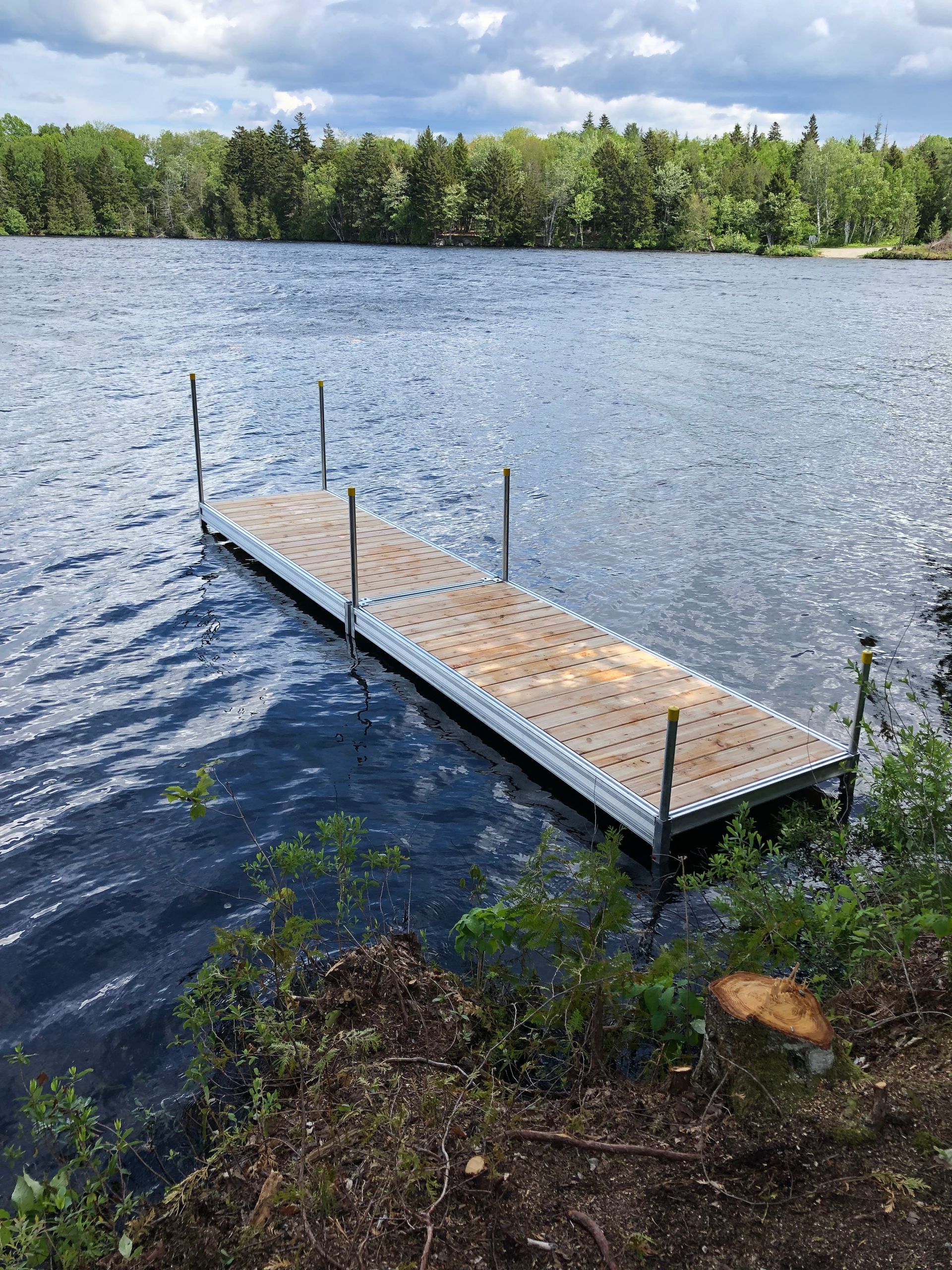 A wooden dock is in the middle of a lake.