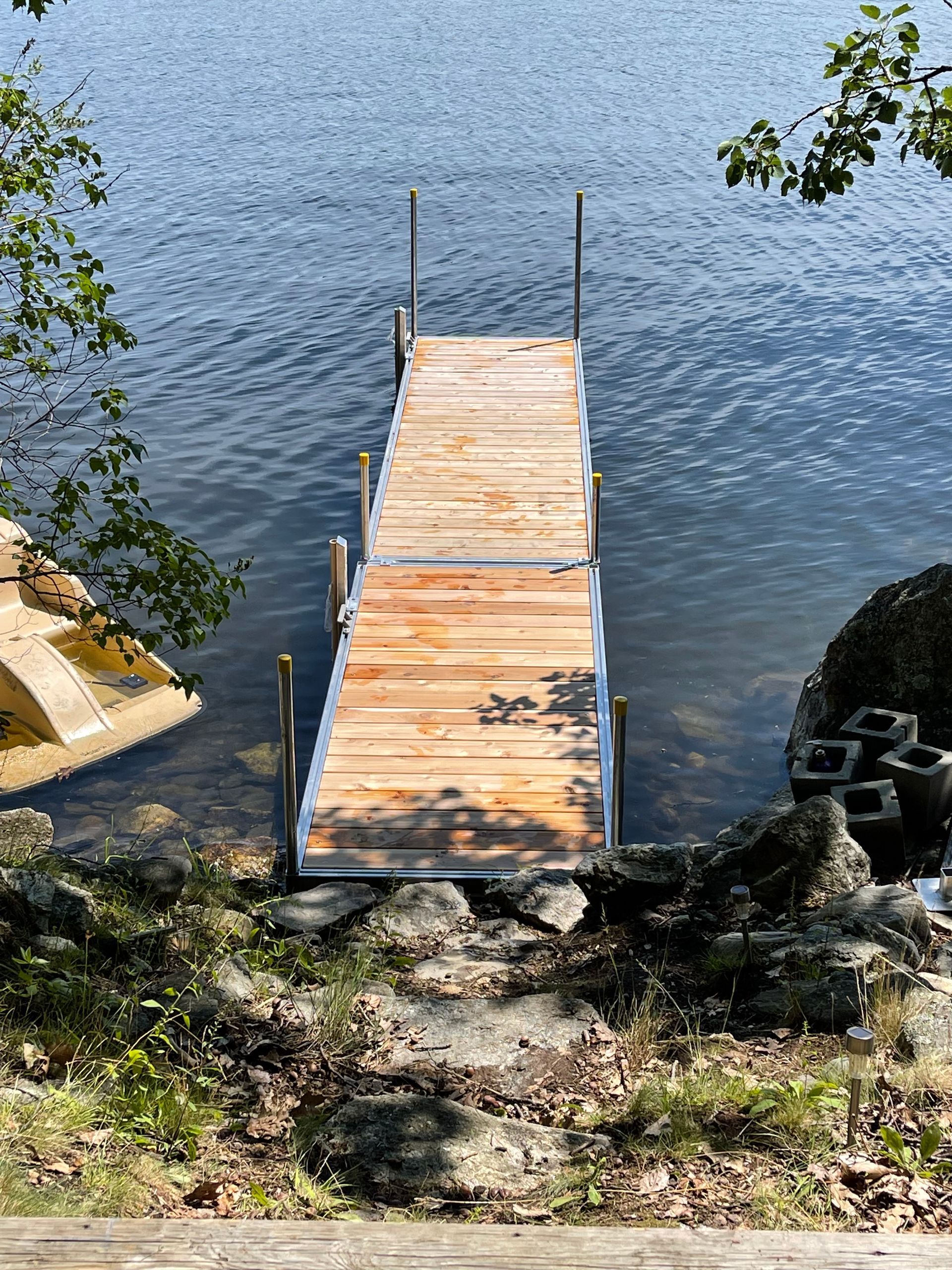 A wooden dock is sitting in the middle of a lake.