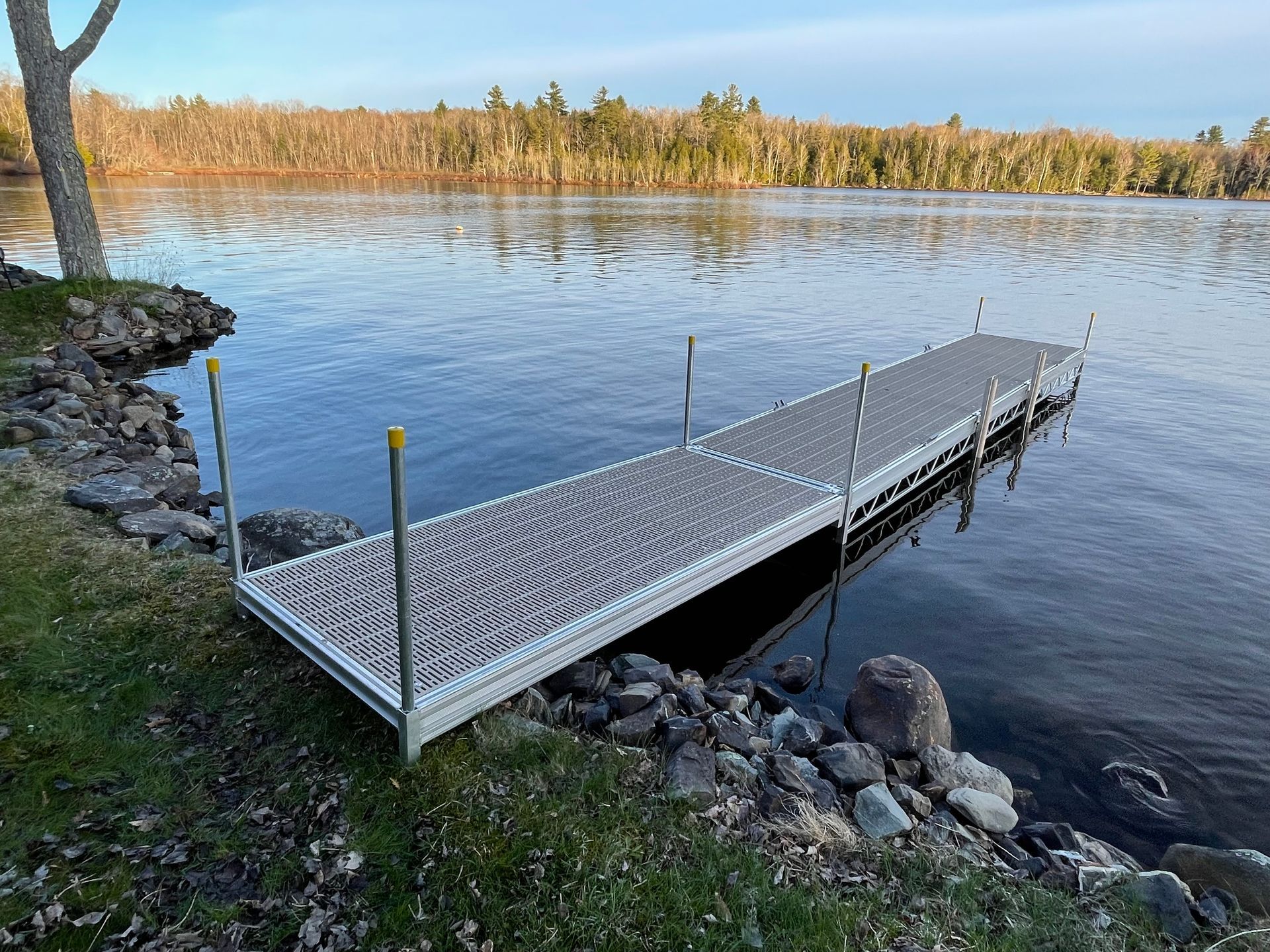 A dock is sitting on the shore of a lake.
