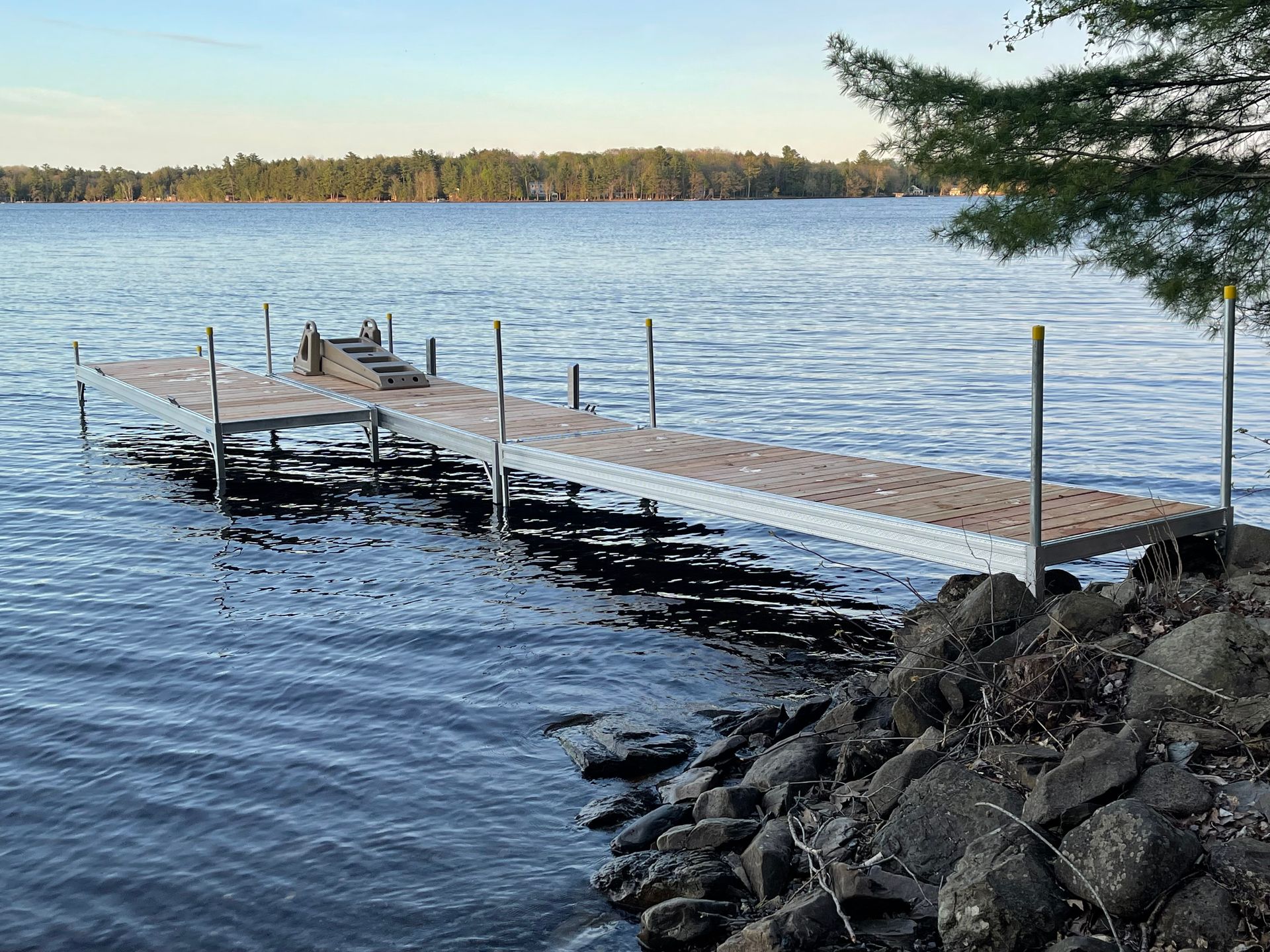 A dock is sitting on the shore of a lake.