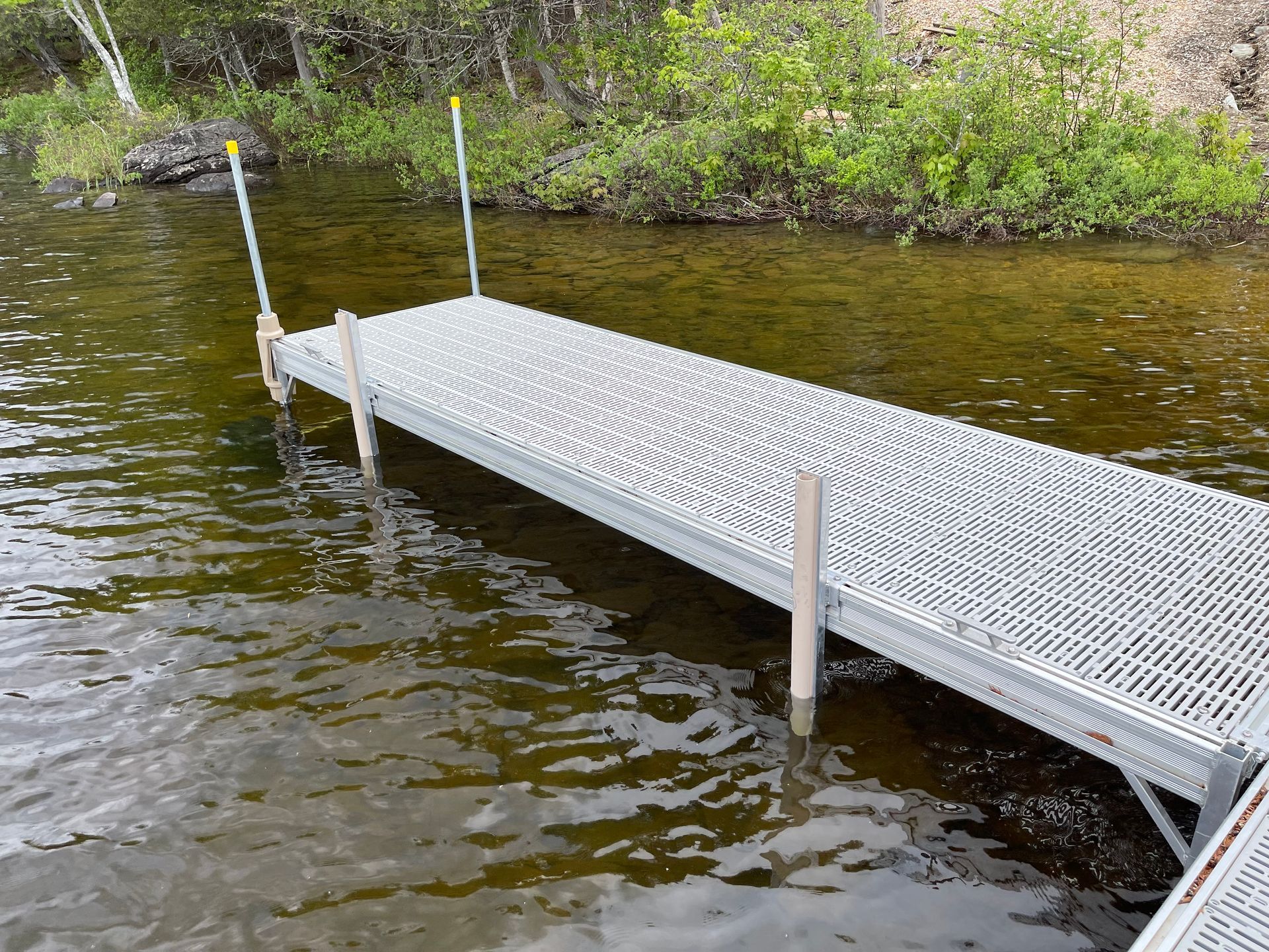 A metal dock is in the middle of a lake.
