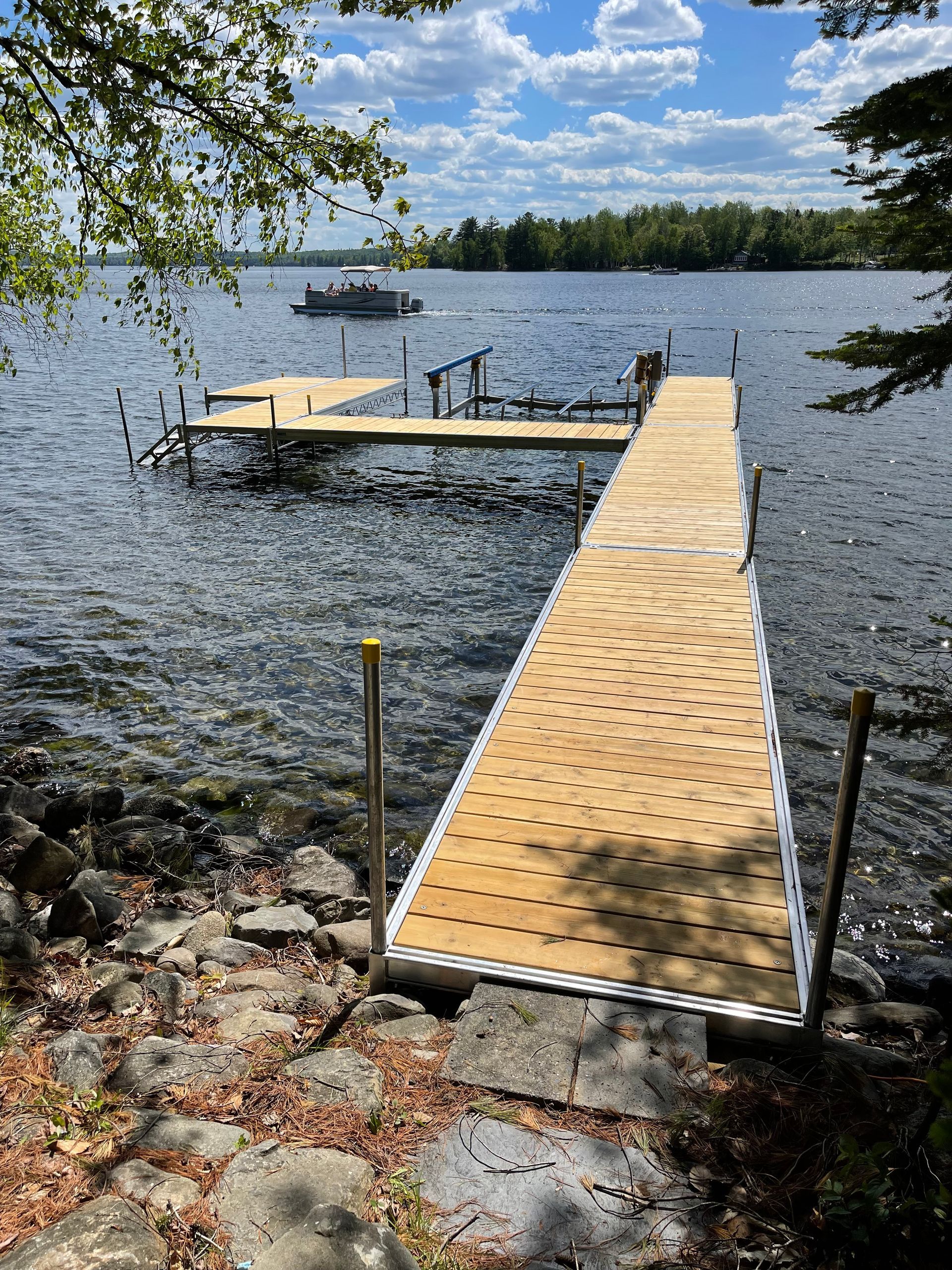 A wooden dock is sitting in the middle of a lake.