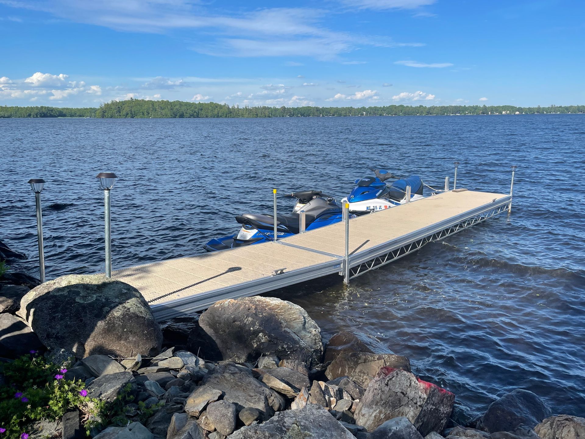 A boat is docked at a dock on a lake.