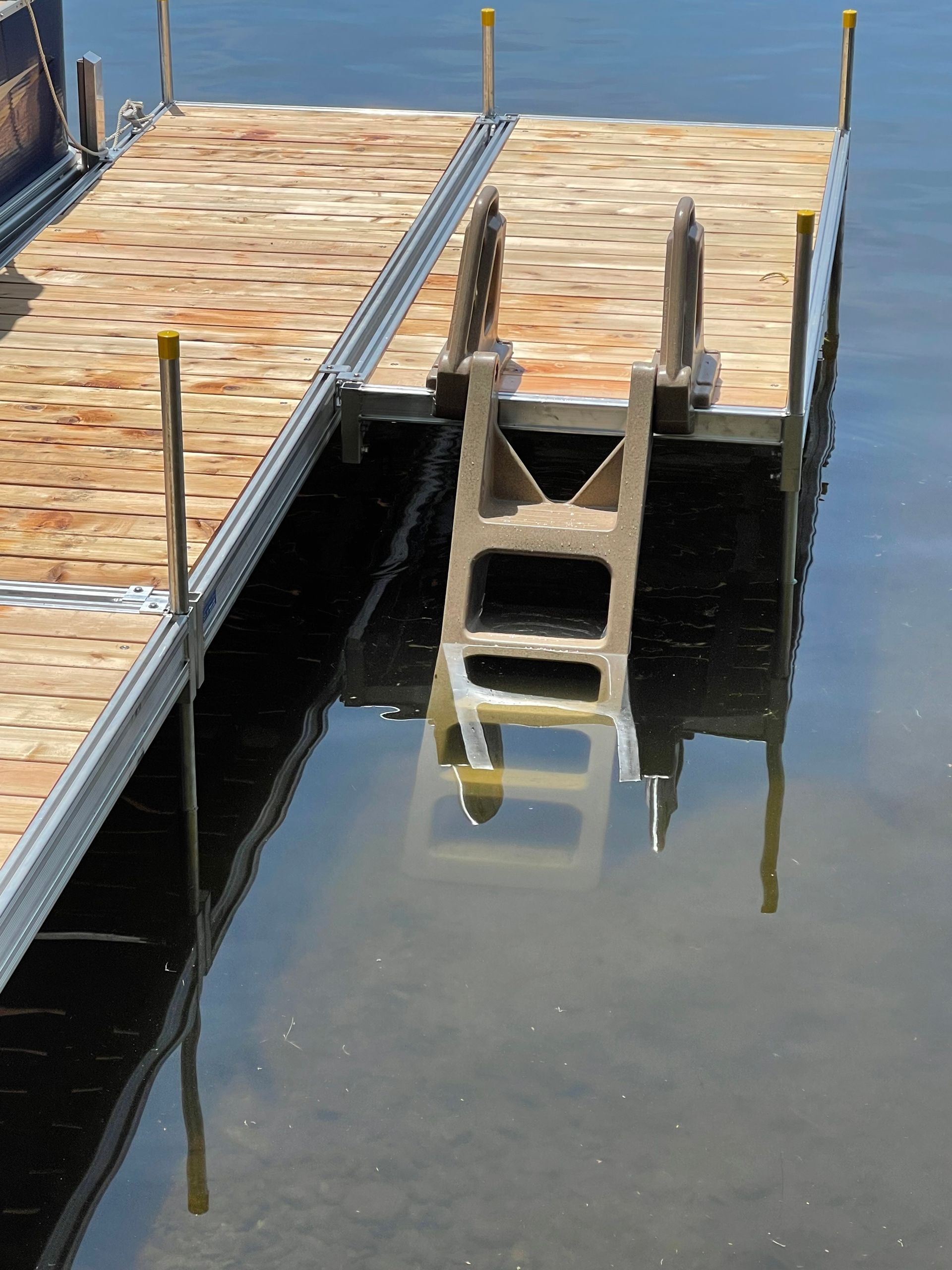 A wooden dock with a ladder in the water