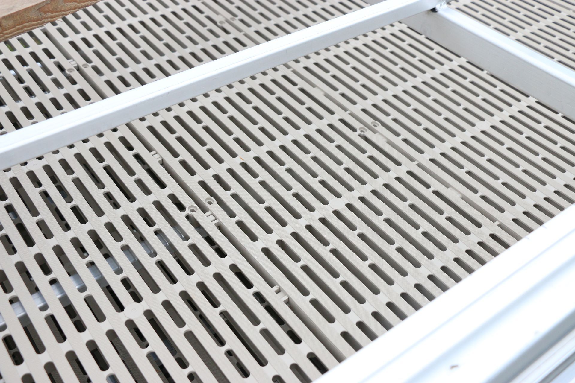 A close up of a metal grate with holes in it.