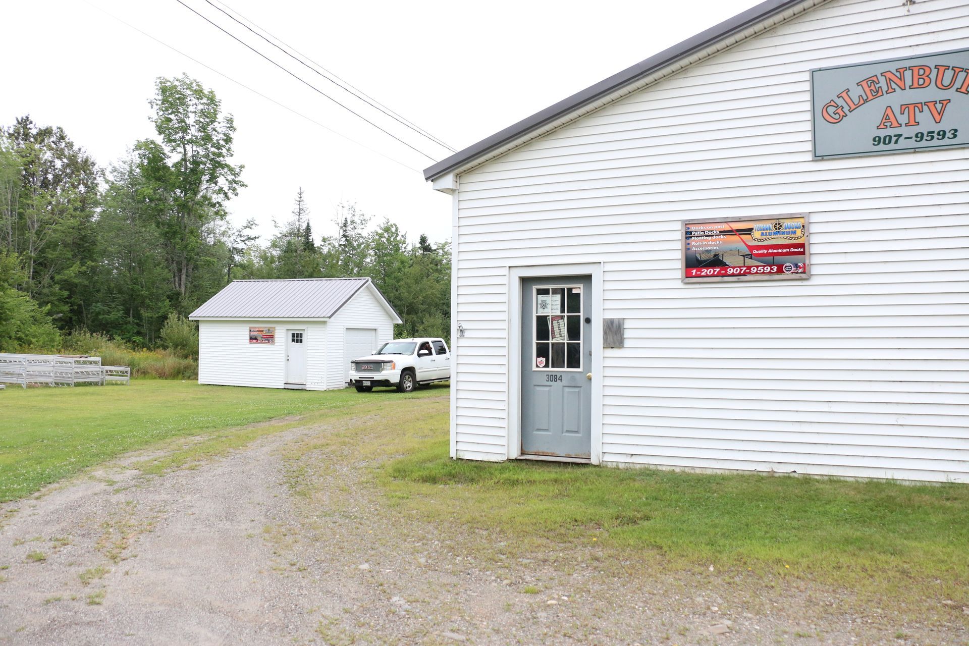 A white building with a sign that says garage sale