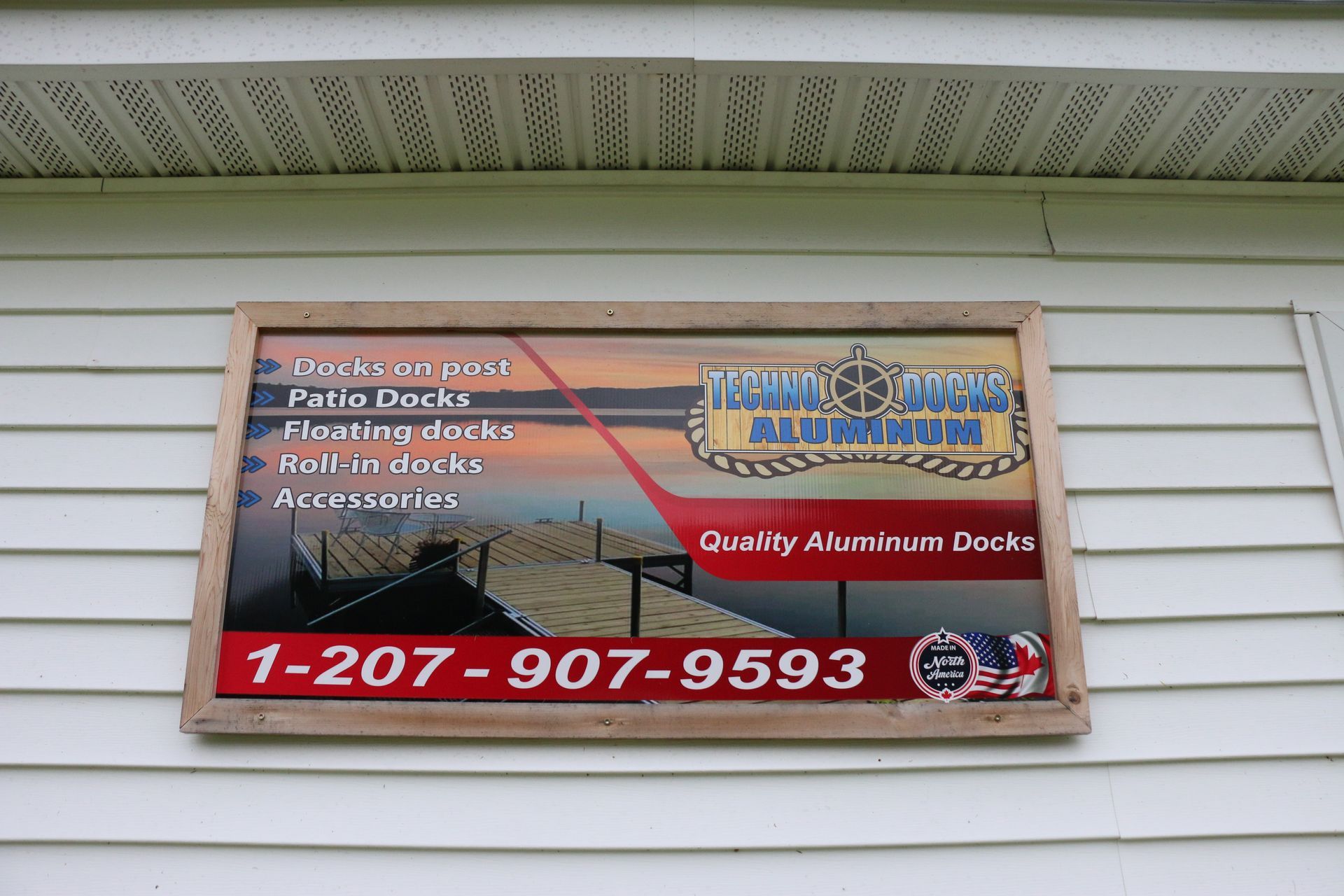 A sign on the side of a house advertising aluminum docks