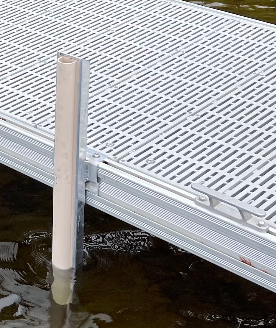 A dock with a wooden post attached to it in the water.