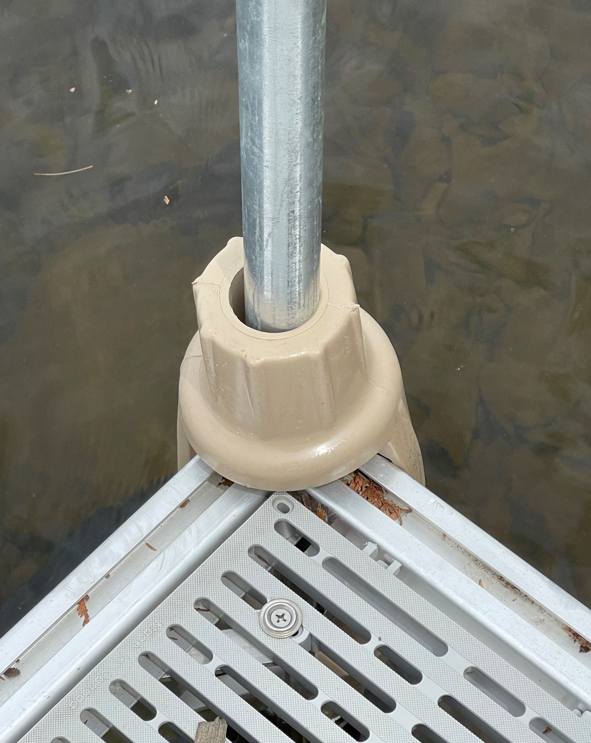 A metal dock with a metal pole attached to it