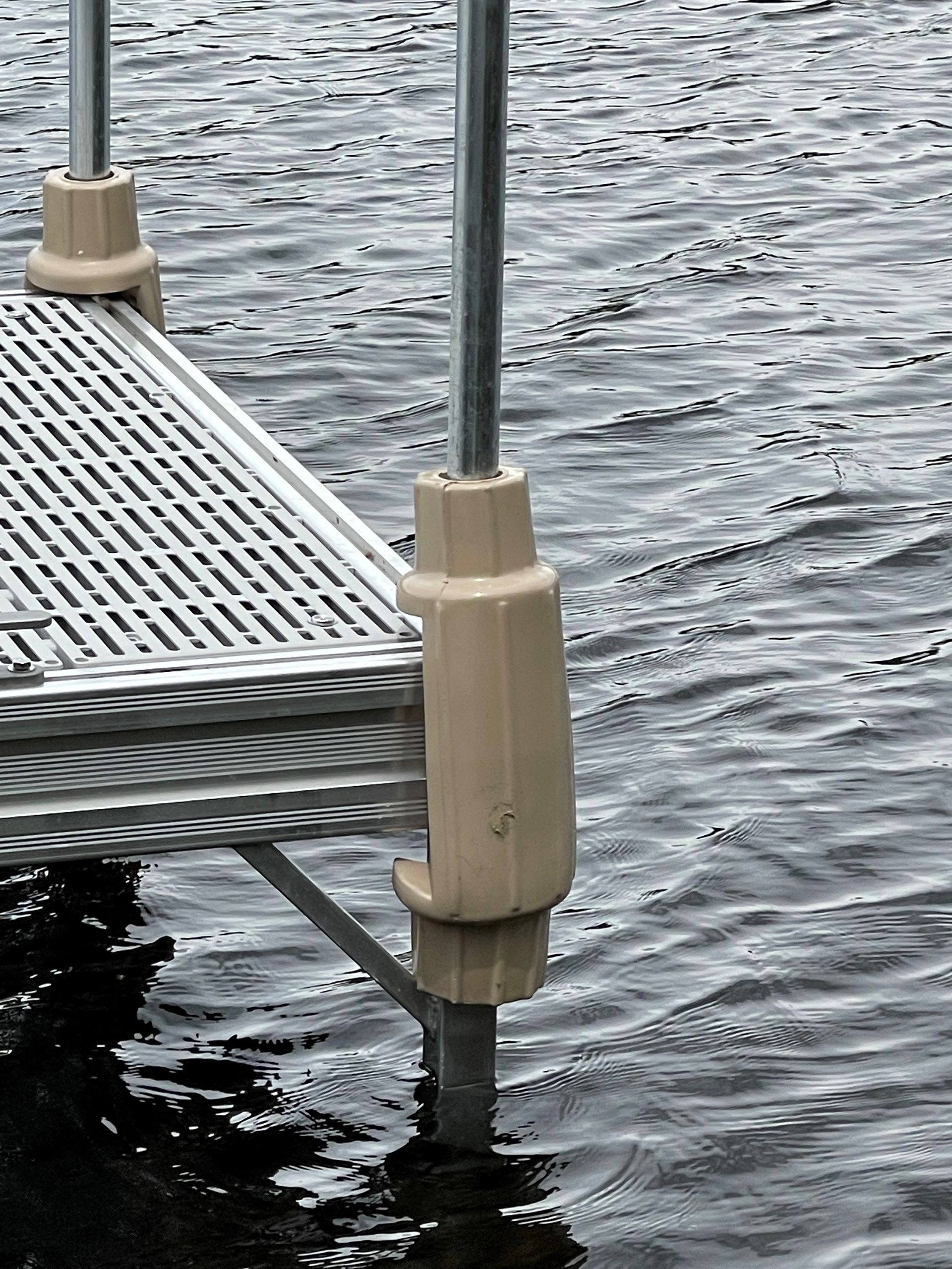 A dock is sitting in the middle of a body of water.