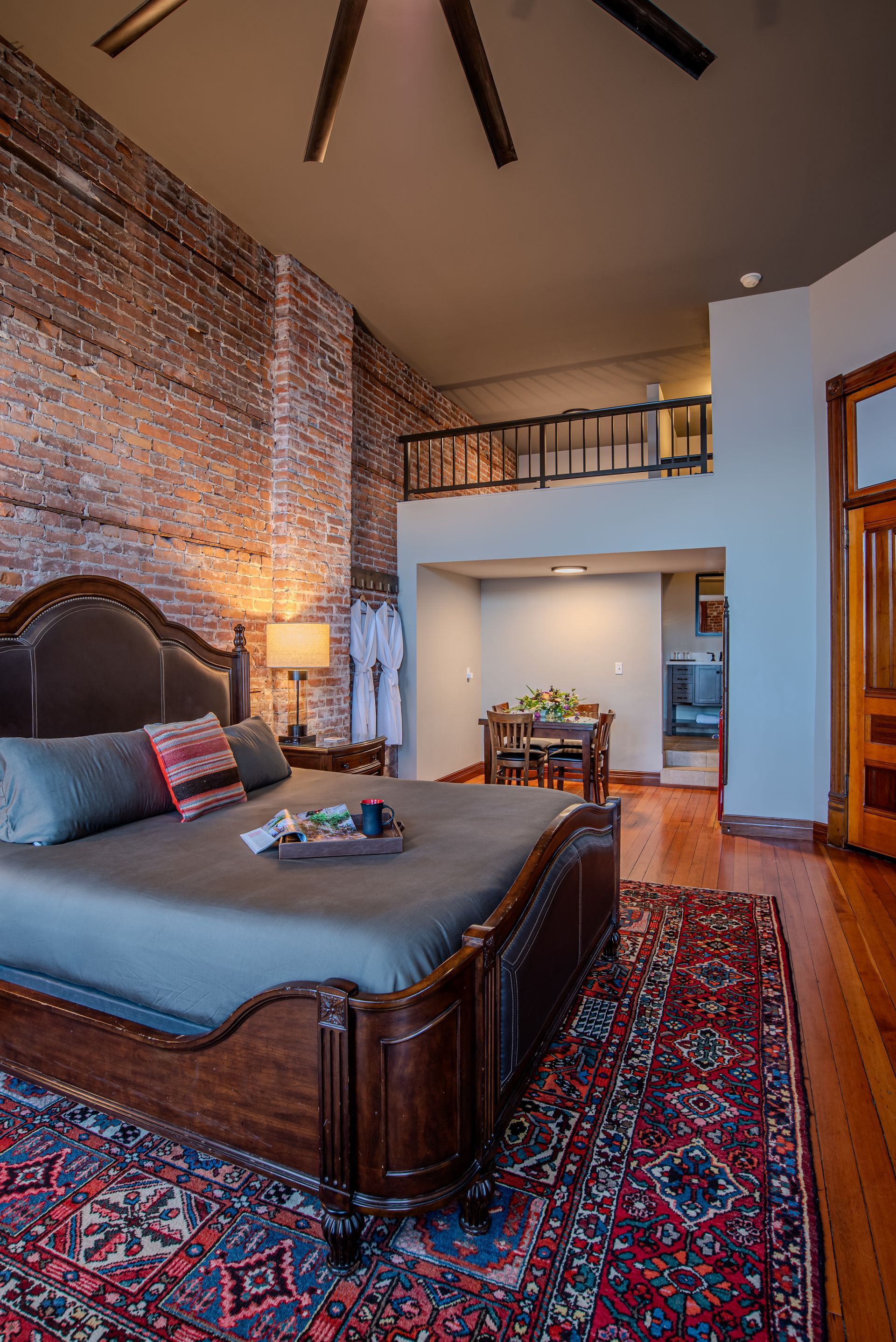 A bedroom with a king size bed and a rug.