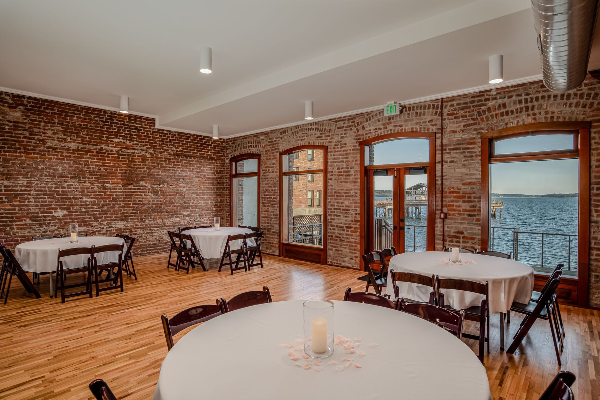 Beautifully restored event space with exposed brick, hardwood floors and stunning views of Port Townsend Bay
