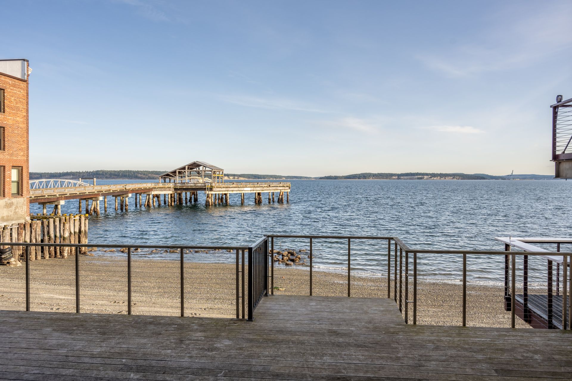 A view of a pier and a body of water from a balcony.