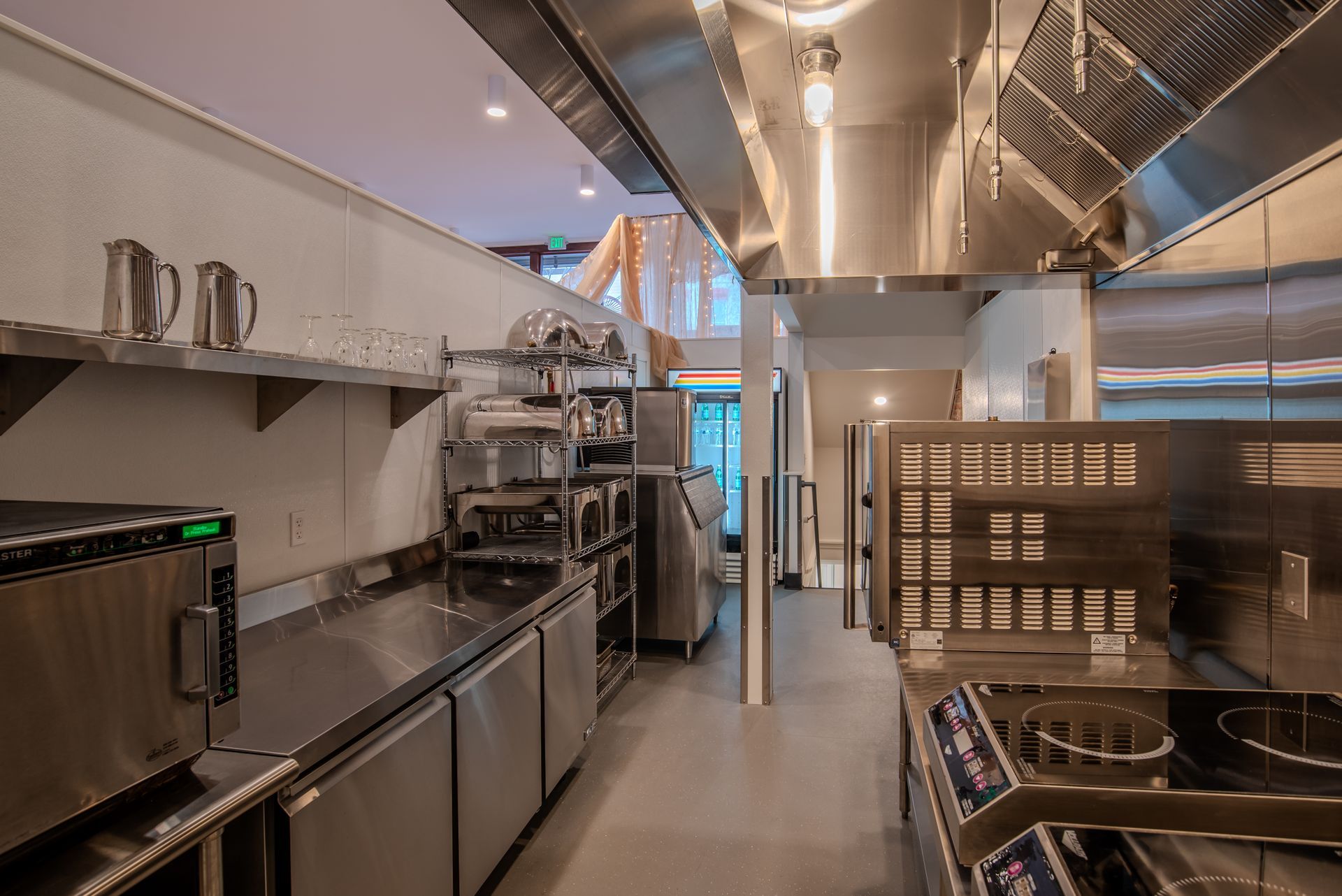 A kitchen with a lot of stainless steel appliances and a stove.