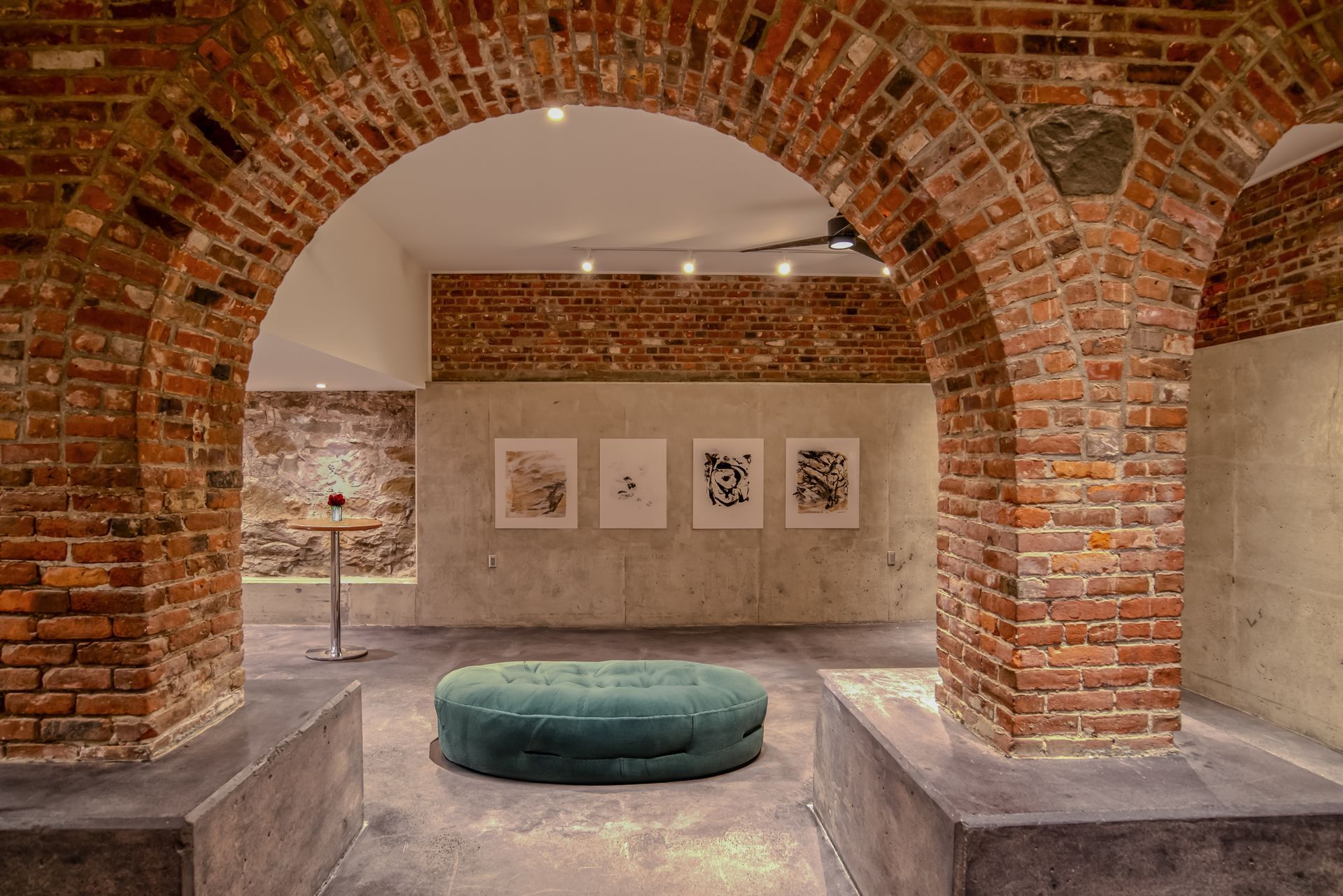 There is a green ottoman in the middle of the room.