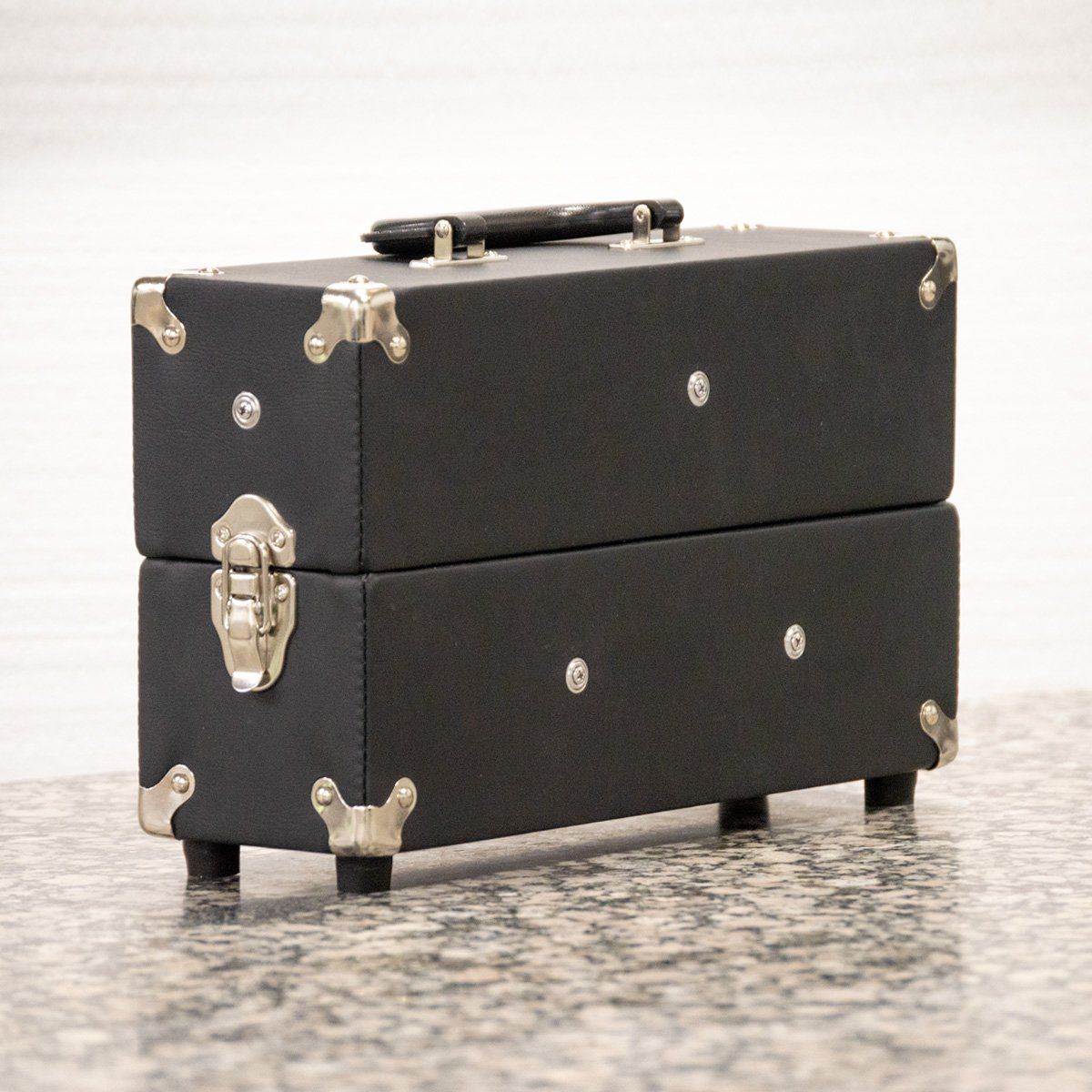 Black case with handle on top and metal clasps