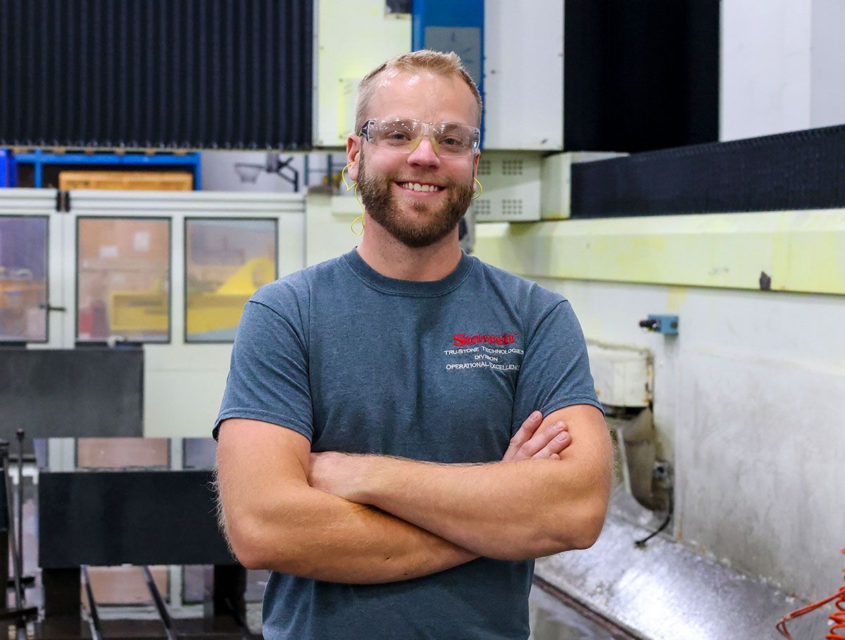 Tru-Stone team member standing in front of machine