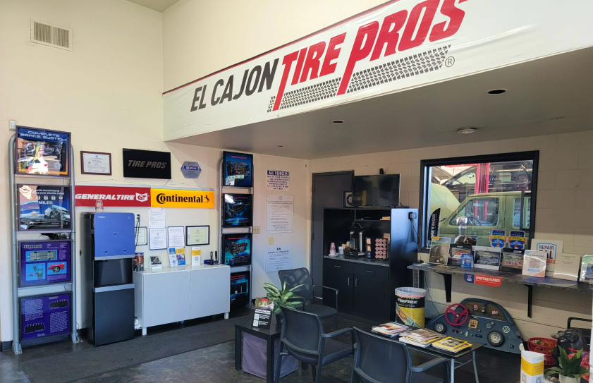 Interior of El Cajon Tire Pros shop; waiting area with tires, seating, and service counter. | El Cajon Tire Pros