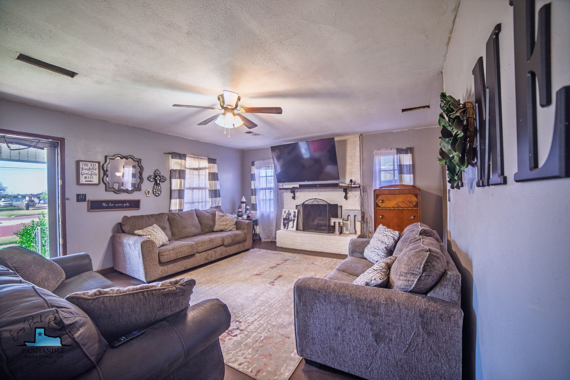 Living room with two couches, fireplace, rug, and