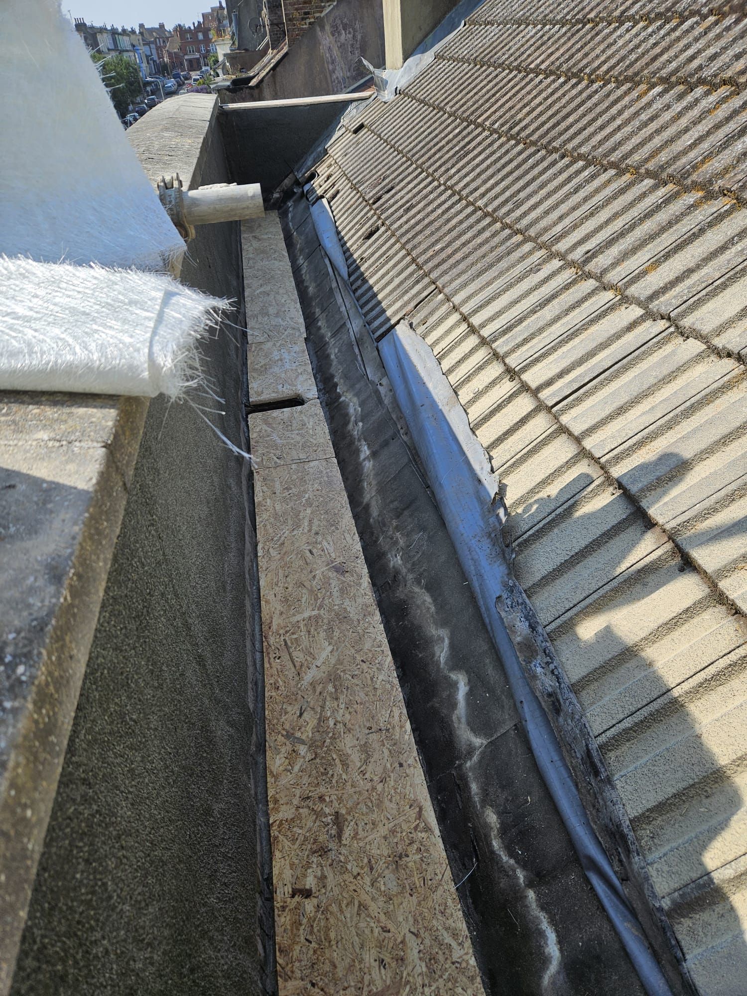 A close up of a gutter on the side of a roof.