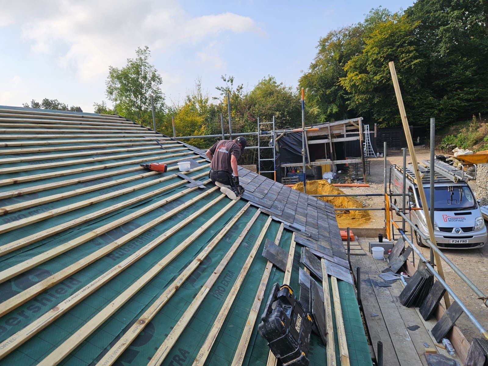 A man is working on the roof of a building.