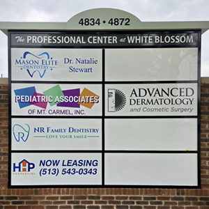 Sign for a professional center with tenant names: Mason Elite Dentistry, Pediatric Associates, NR Family Dentistry, and more.