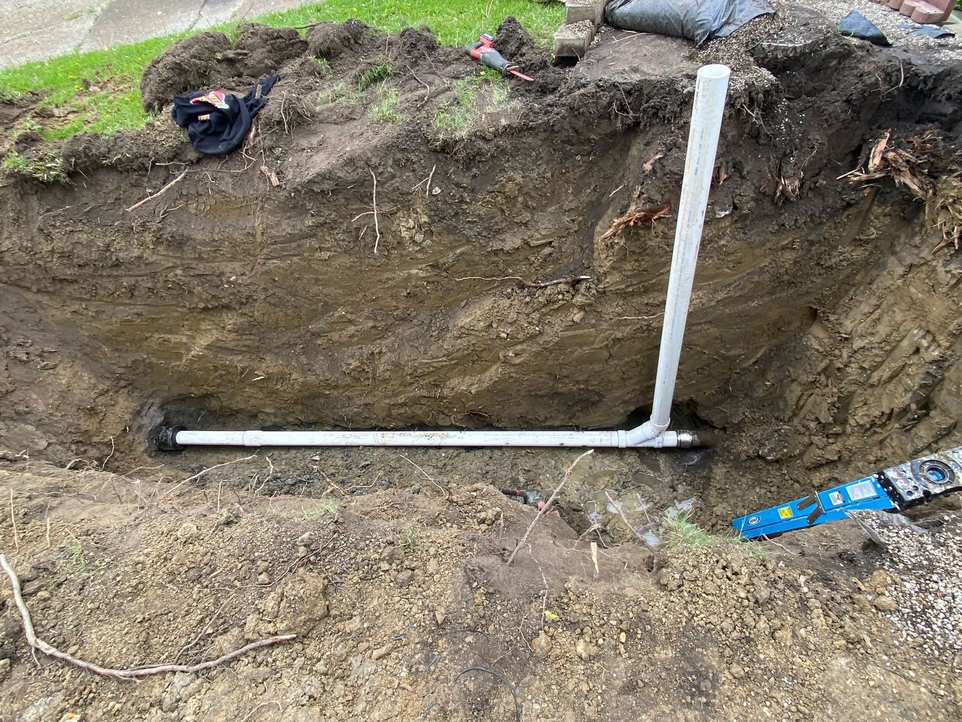A pipe is being installed in a hole in the ground.