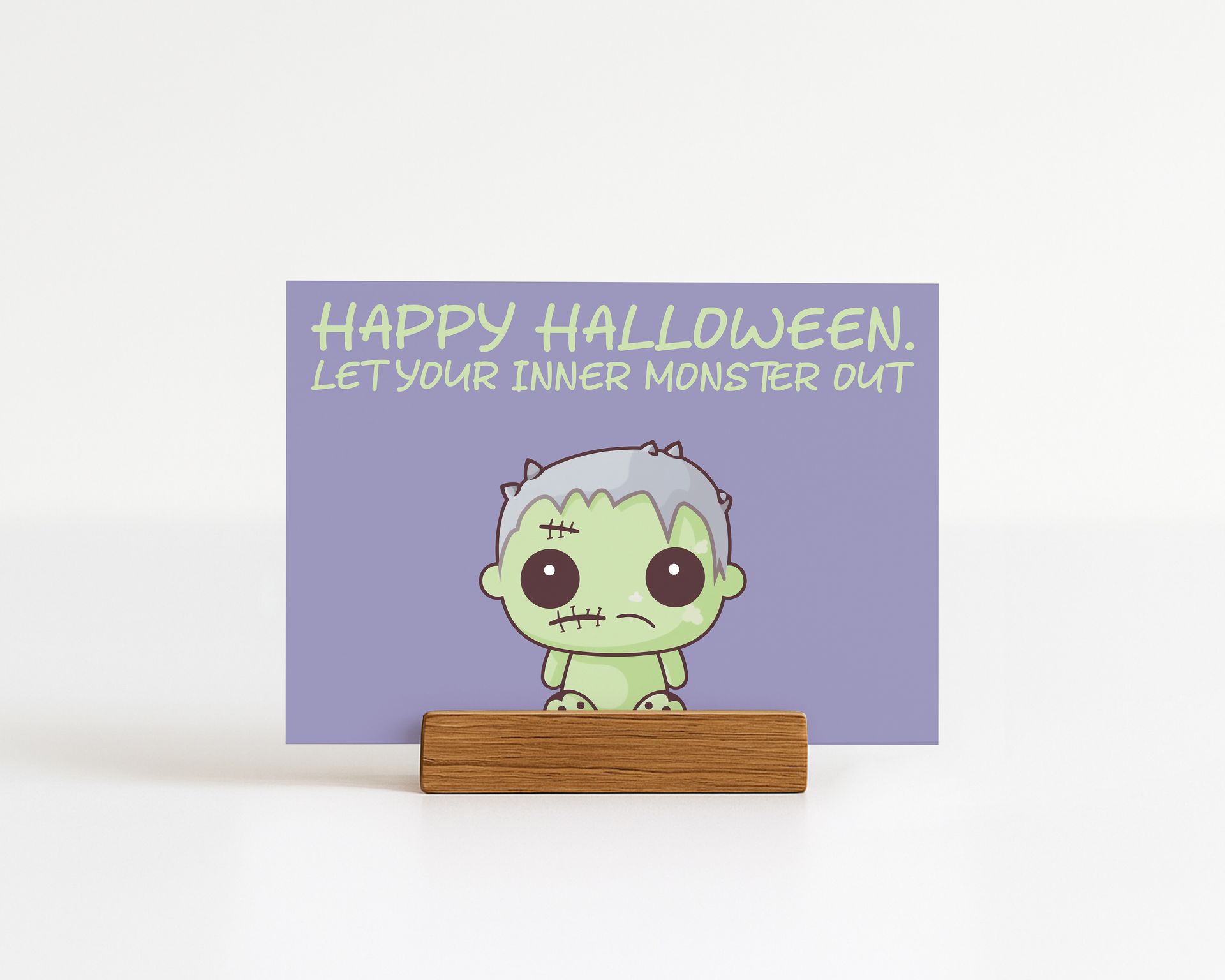 Halloween greeting card with cartoon Frankenstein, text