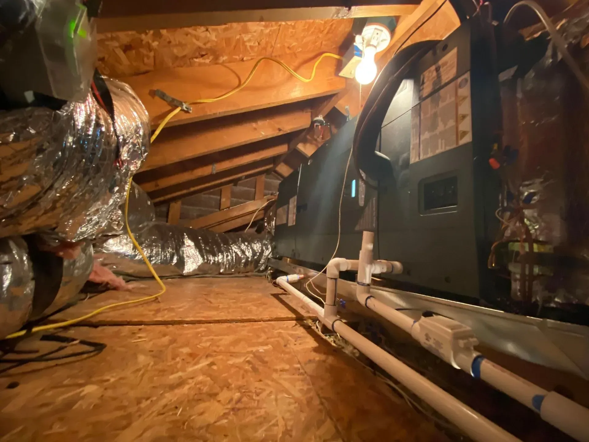 There are a lot of pipes and ducts in the attic.