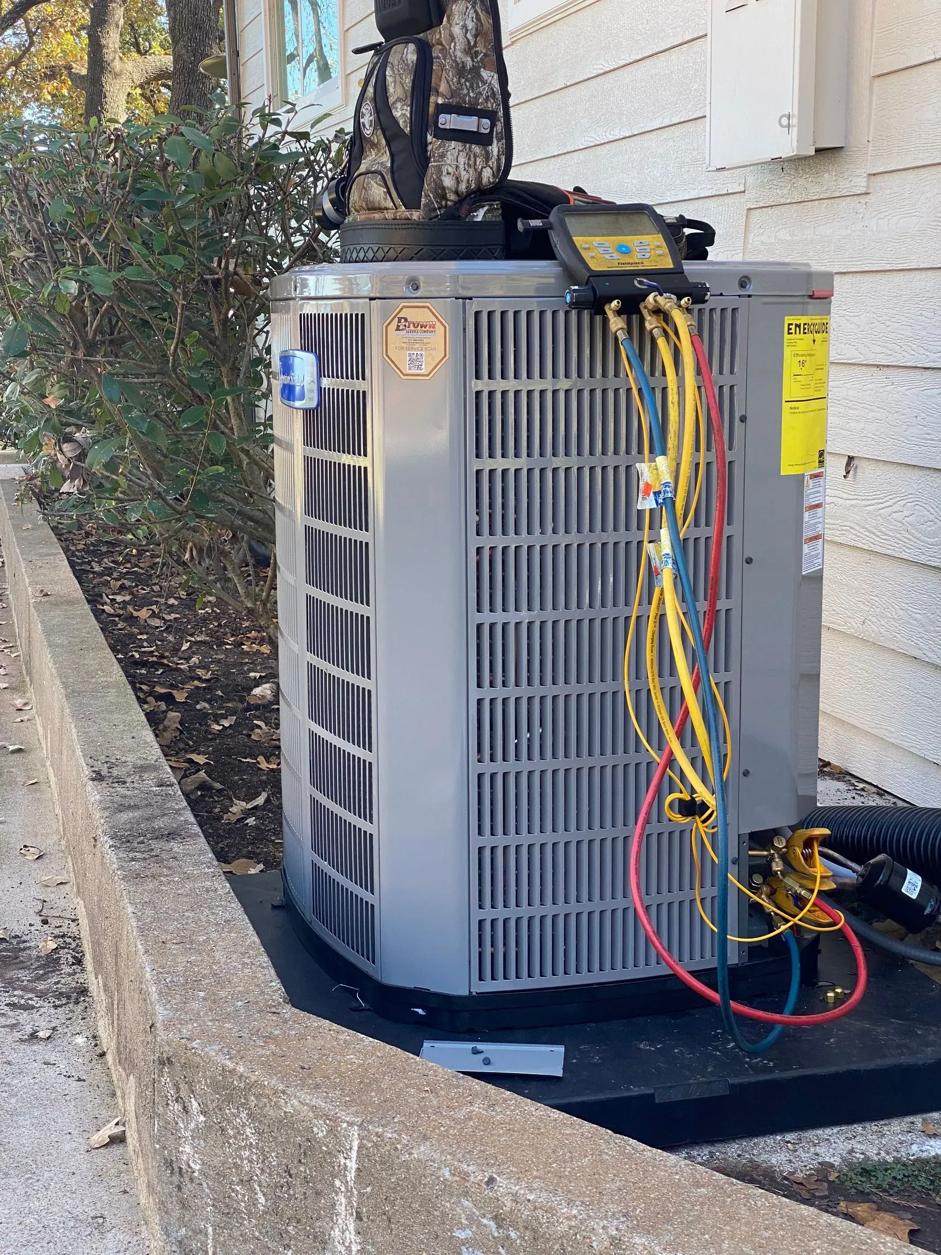 A large air conditioner is sitting on the side of a building.